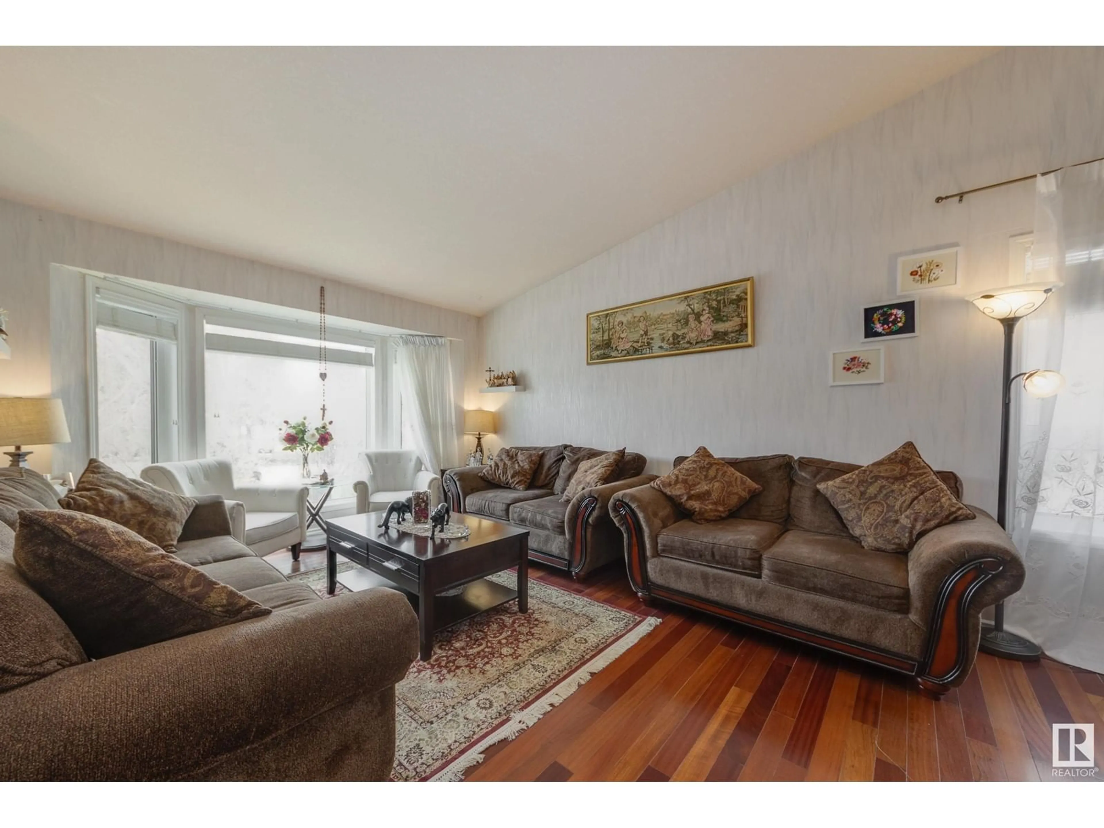 Living room with furniture, wood/laminate floor for NW - 6217 13 AV, Edmonton Alberta T6L2E5
