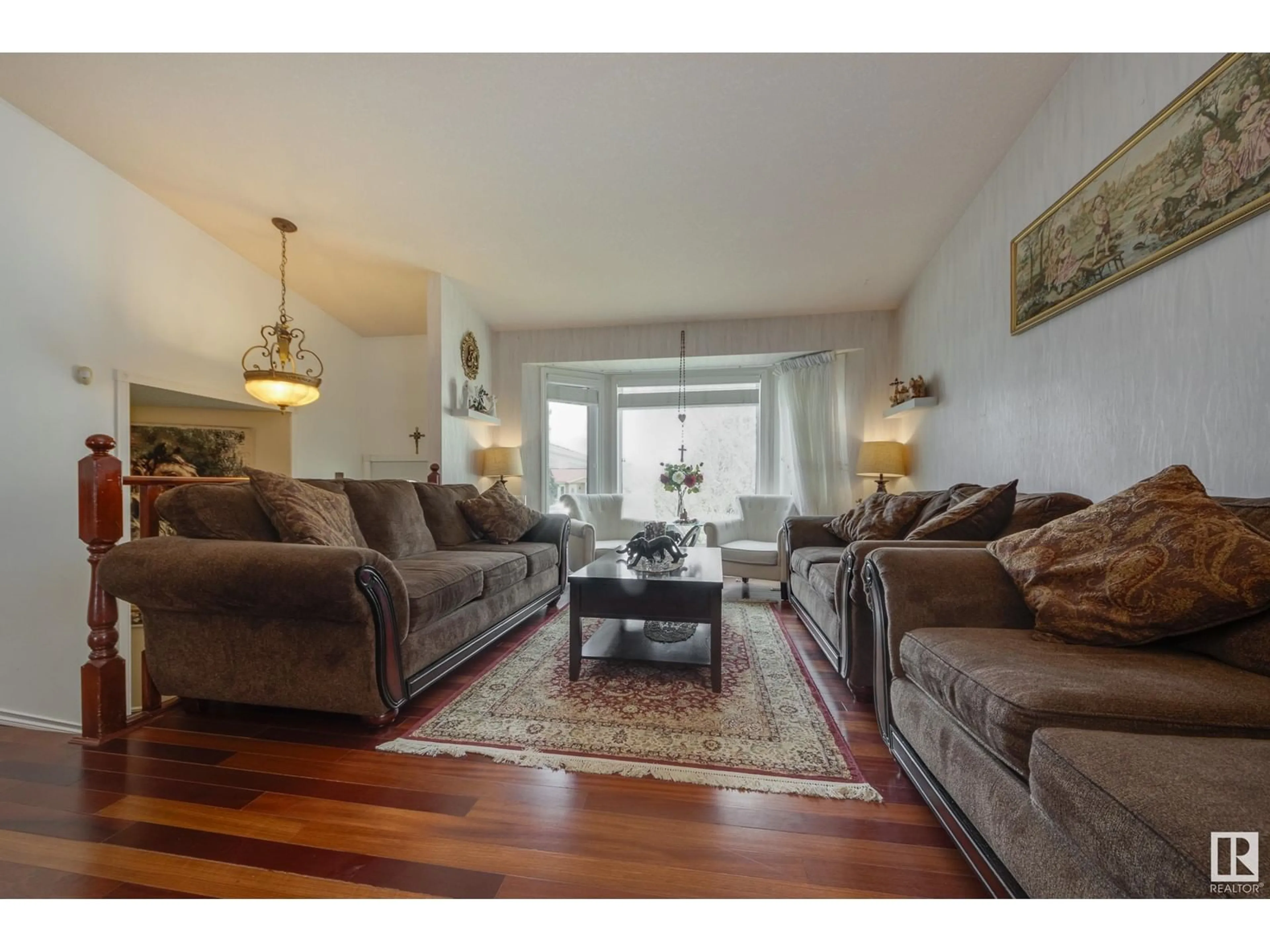 Living room with furniture, wood/laminate floor for NW - 6217 13 AV, Edmonton Alberta T6L2E5