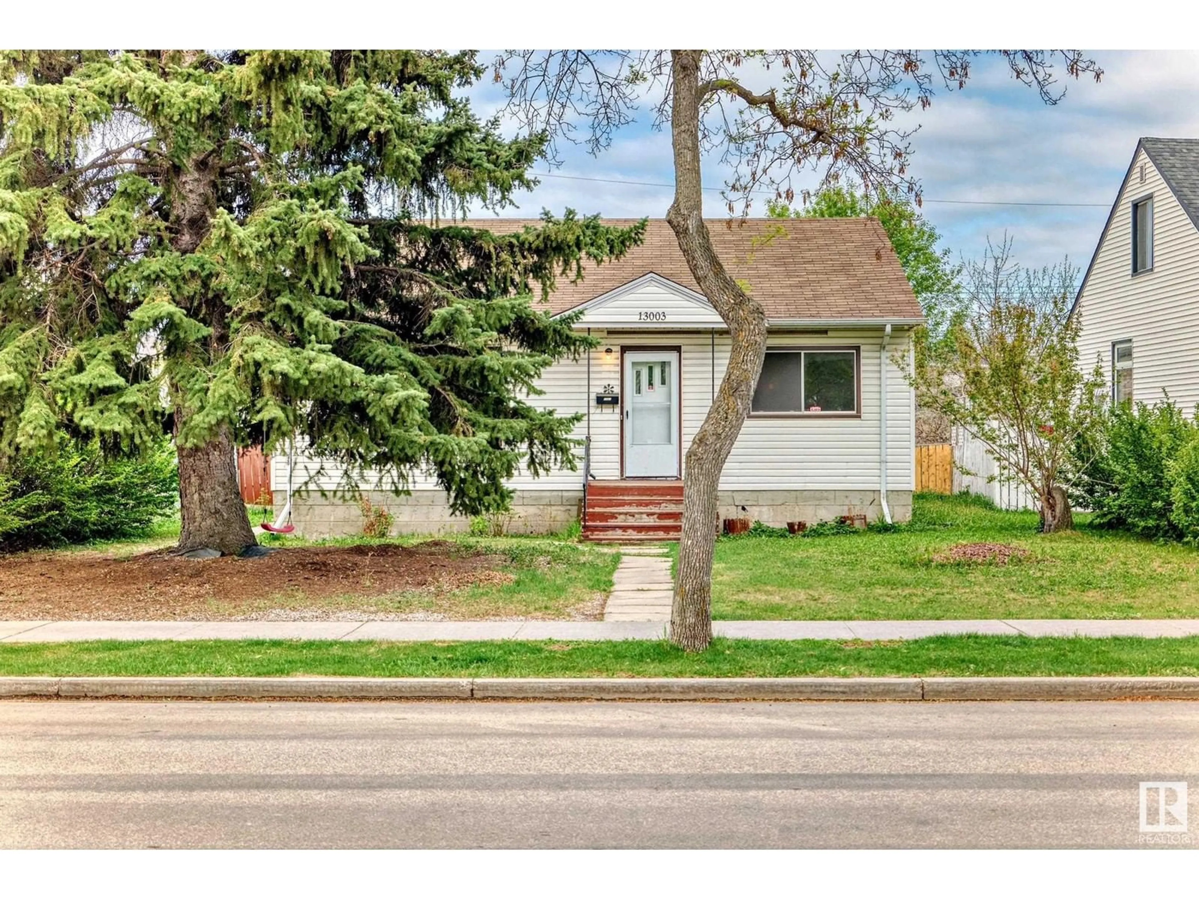 Home with vinyl exterior material, street for 13003 SHERBROOKE AV, Edmonton Alberta T5L4E6
