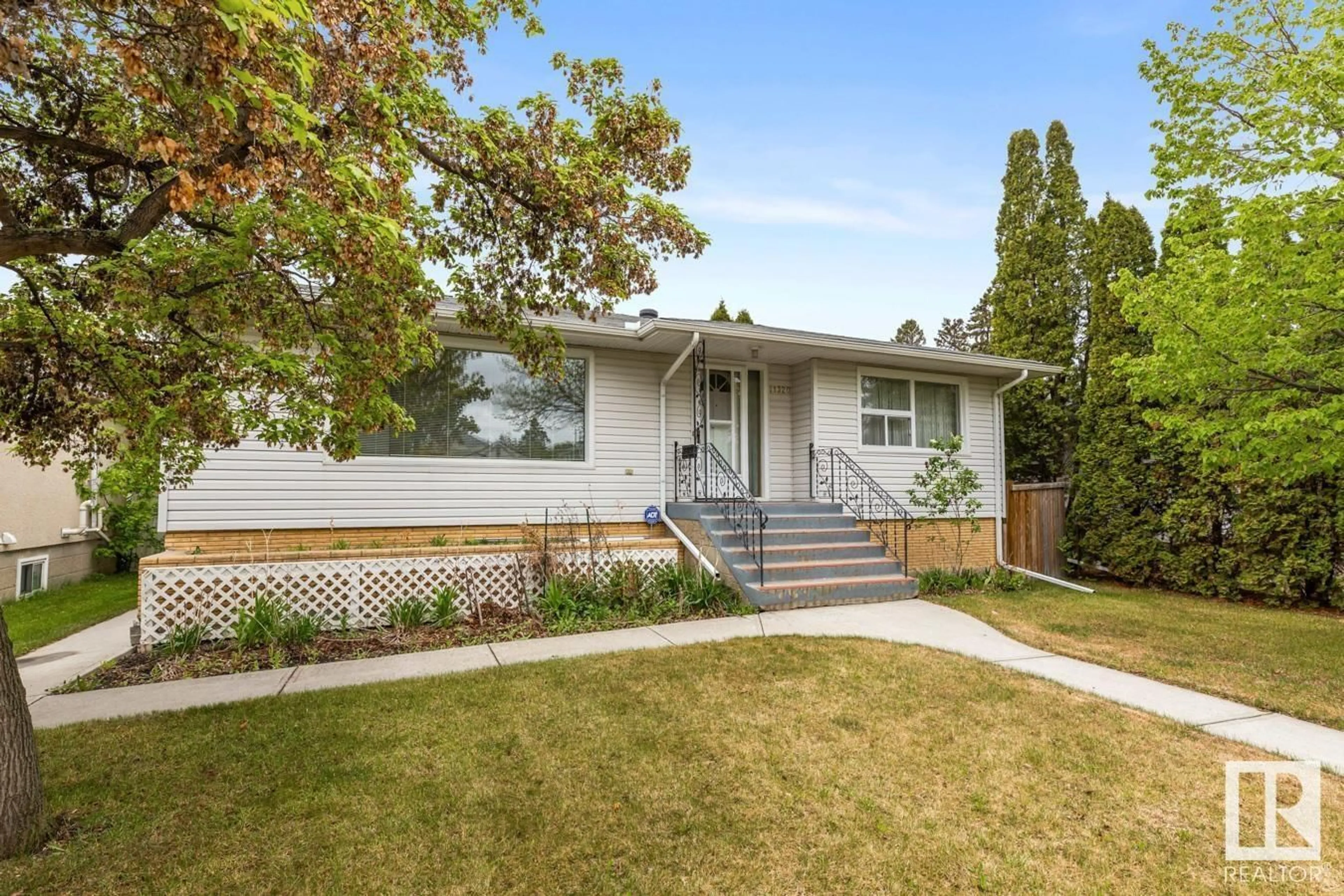 Home with vinyl exterior material, street for NW - 11320 102 ST, Edmonton Alberta T5G2E4
