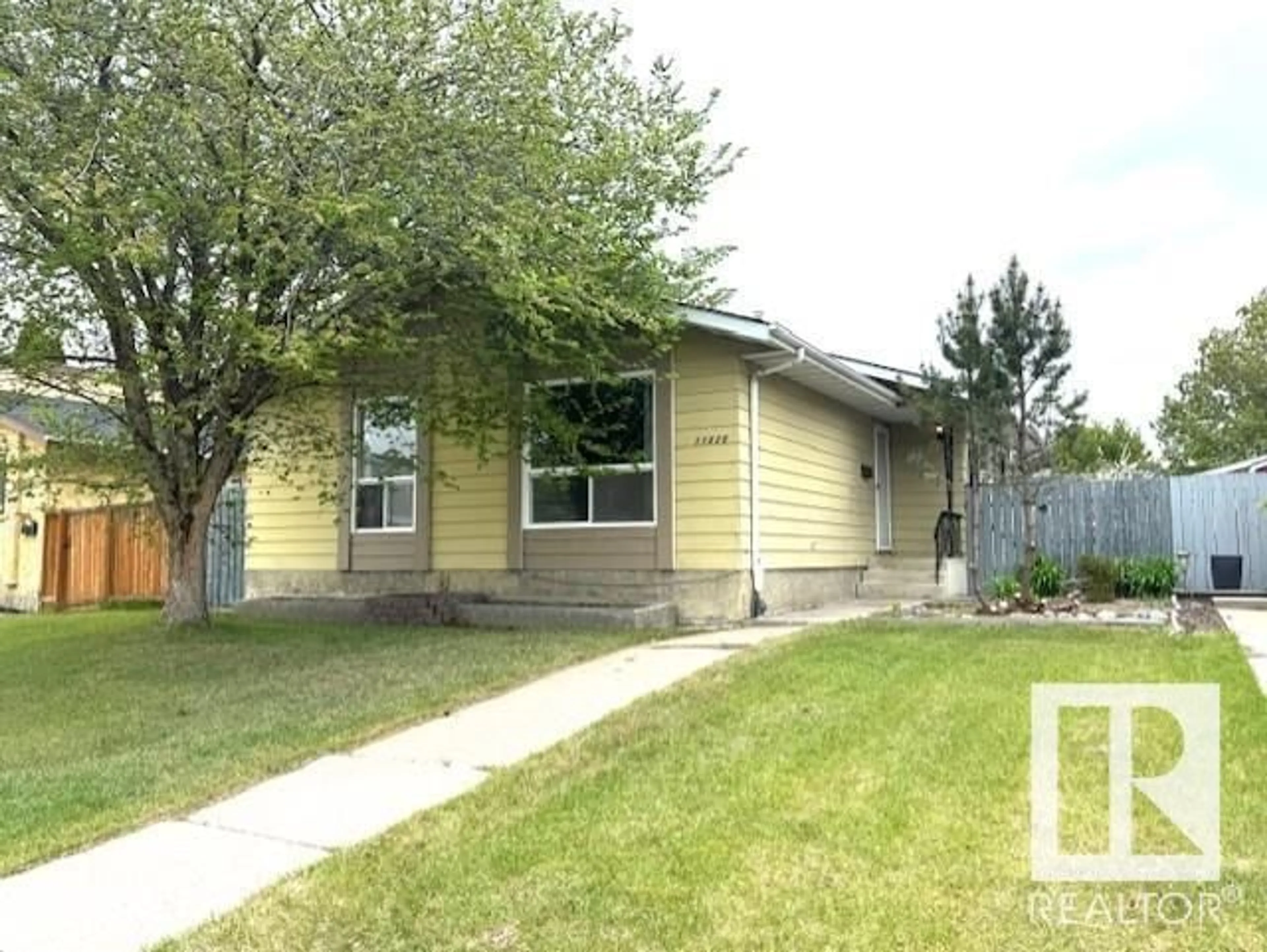 Home with vinyl exterior material, street for NW - 11820 152 AV, Edmonton Alberta T5X1E1
