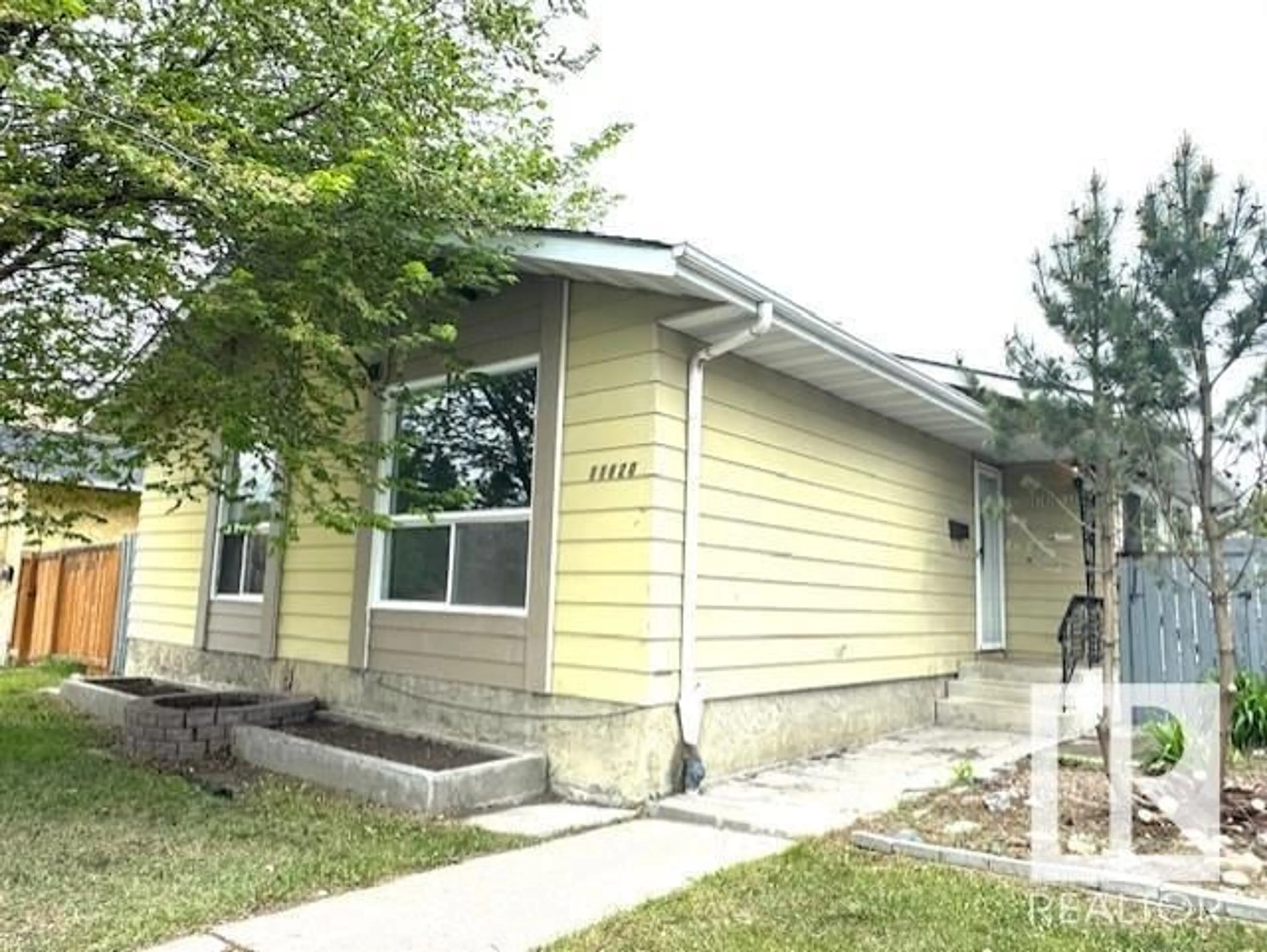 Home with vinyl exterior material, street for NW - 11820 152 AV, Edmonton Alberta T5X1E1