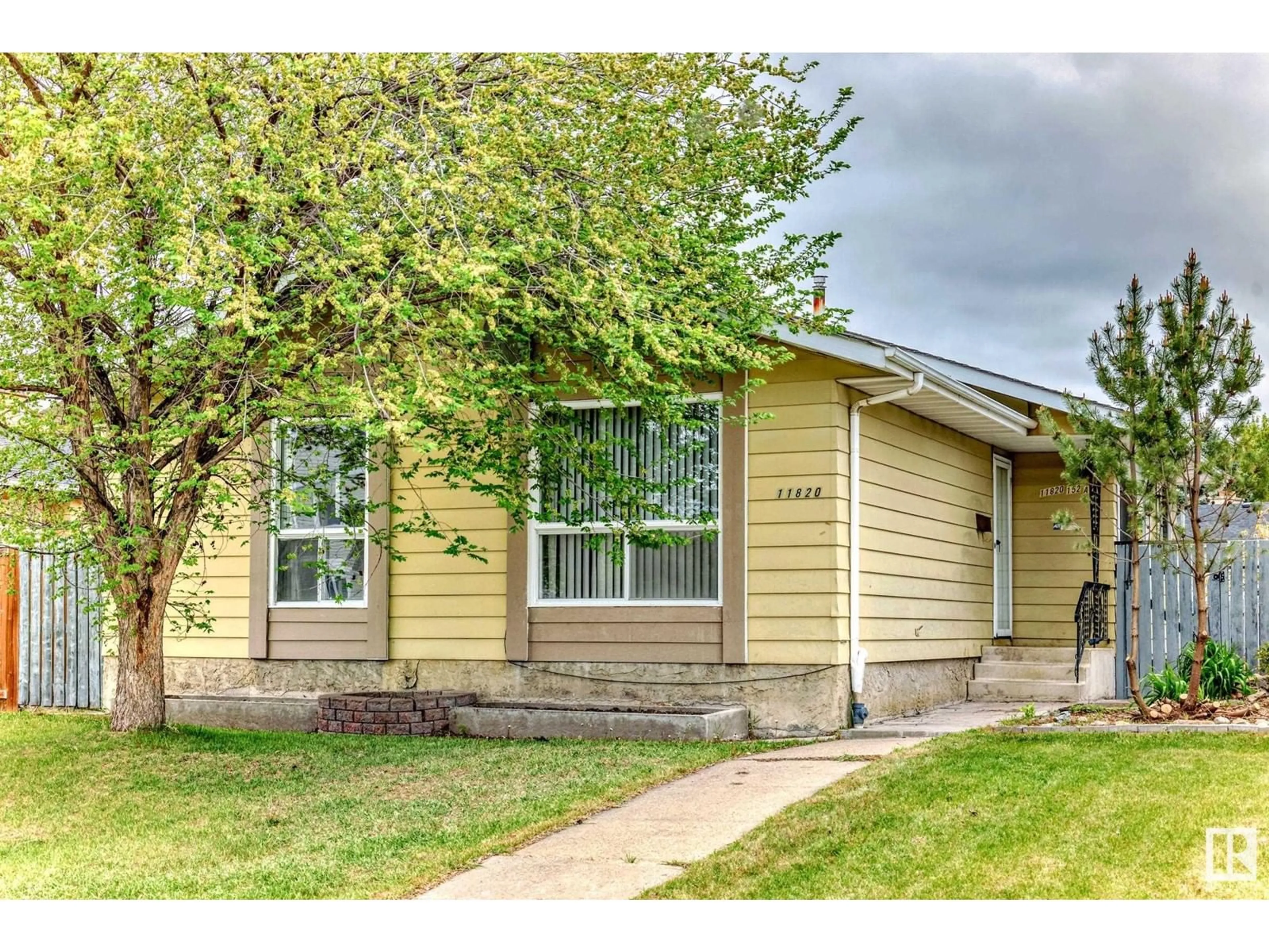 Home with vinyl exterior material, street for NW - 11820 152 AV, Edmonton Alberta T5X1E1