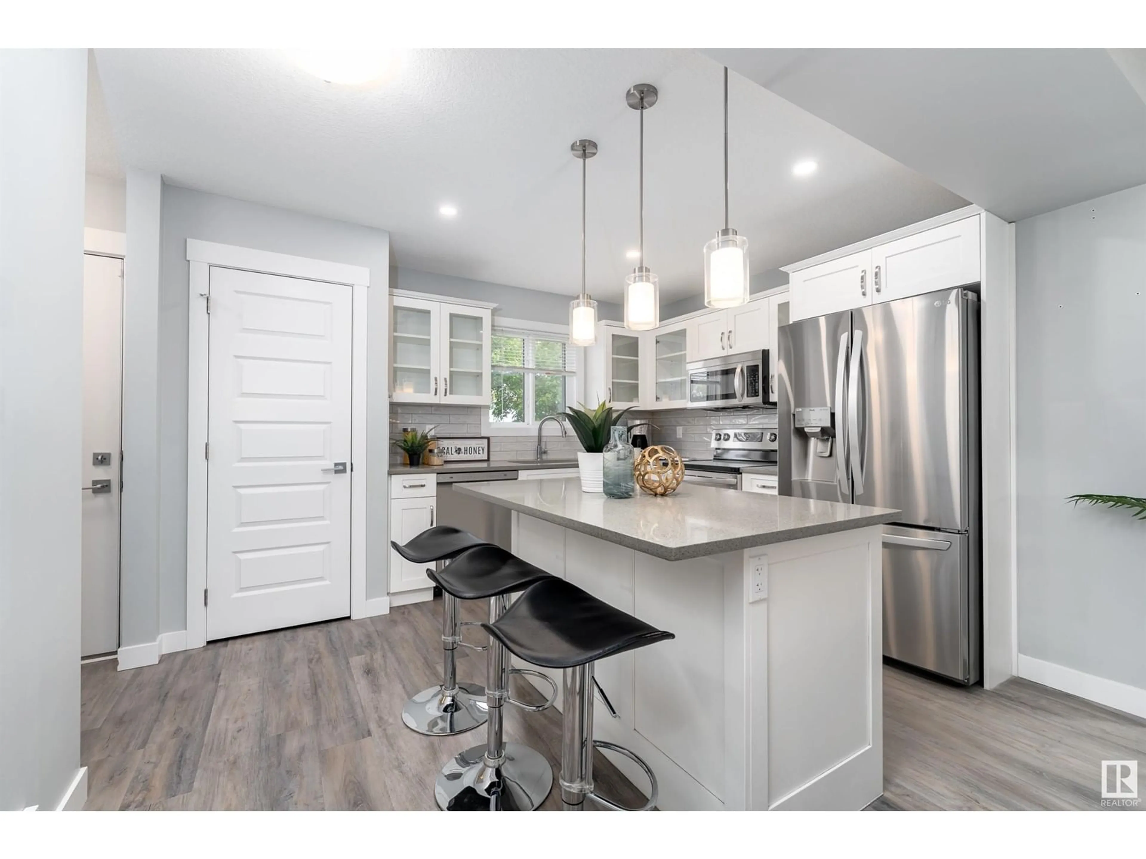 Open concept kitchen, wood/laminate floor for 12929 69 ST, Edmonton Alberta T5C0H3