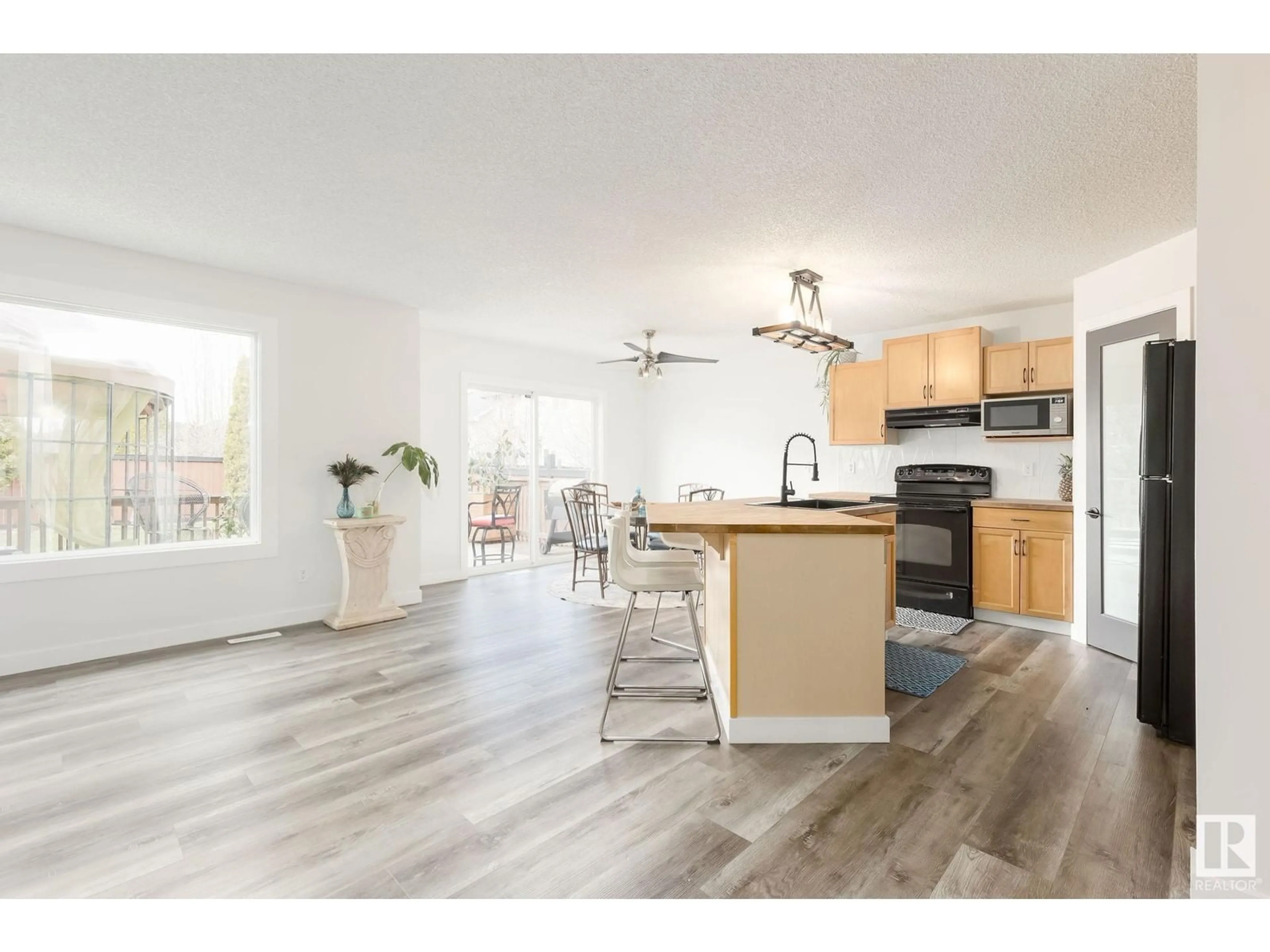 Open concept kitchen, wood/laminate floor for 94 RUE MONETTE, Beaumont Alberta T4X1T1