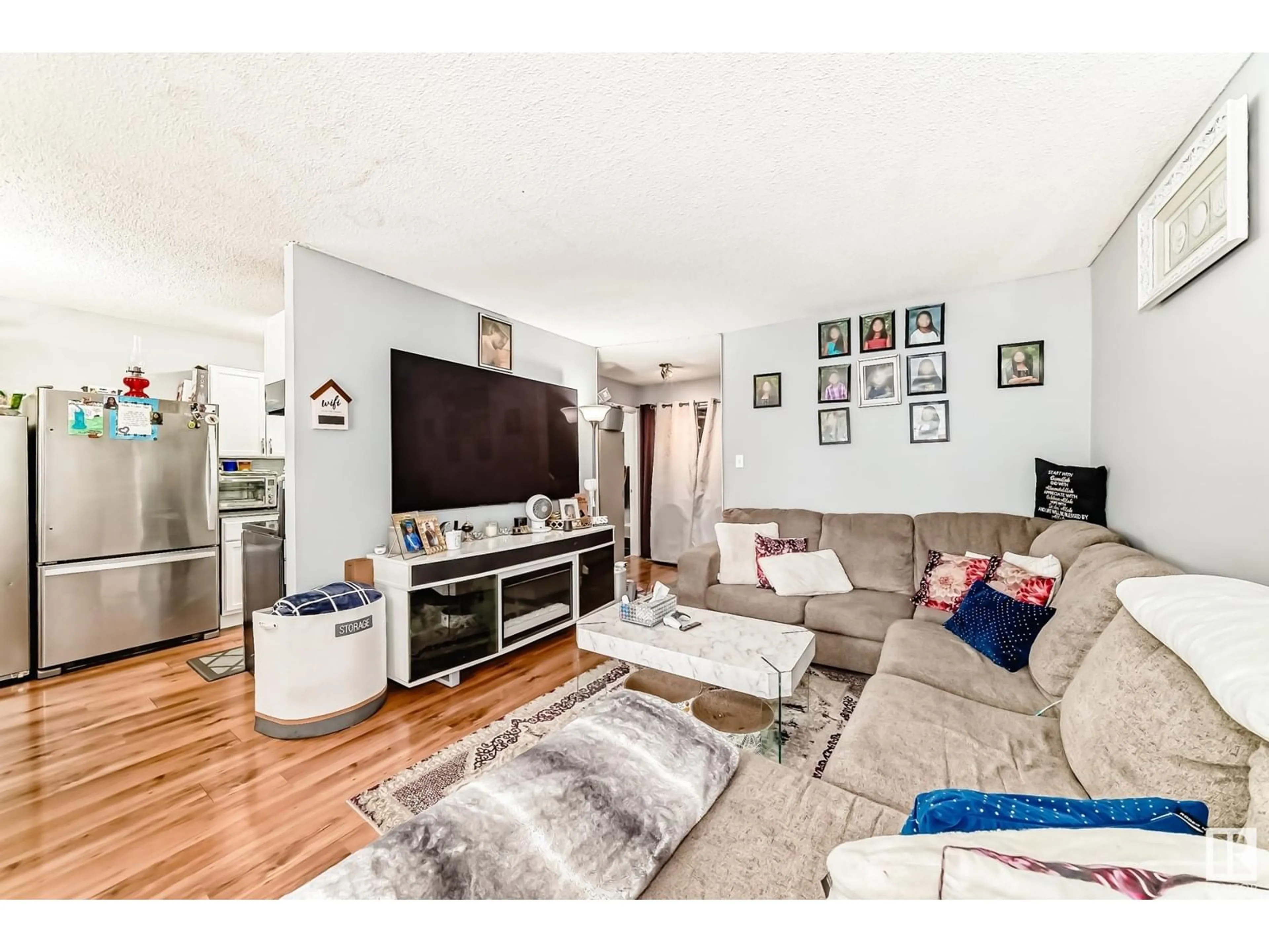 Living room with furniture, wood/laminate floor for 13458 FORT RD, Edmonton Alberta T5A1C5