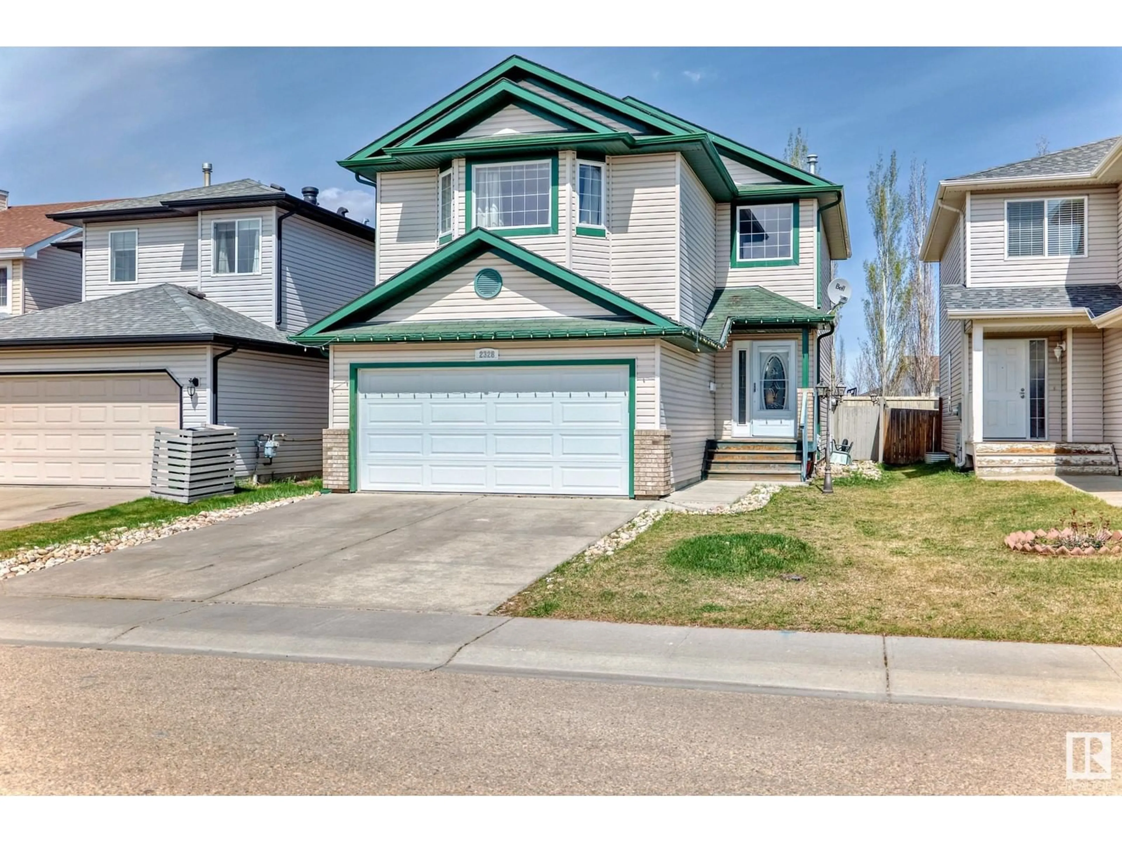 Home with vinyl exterior material, street for 2328 32 AV, Edmonton Alberta T6T1Z7
