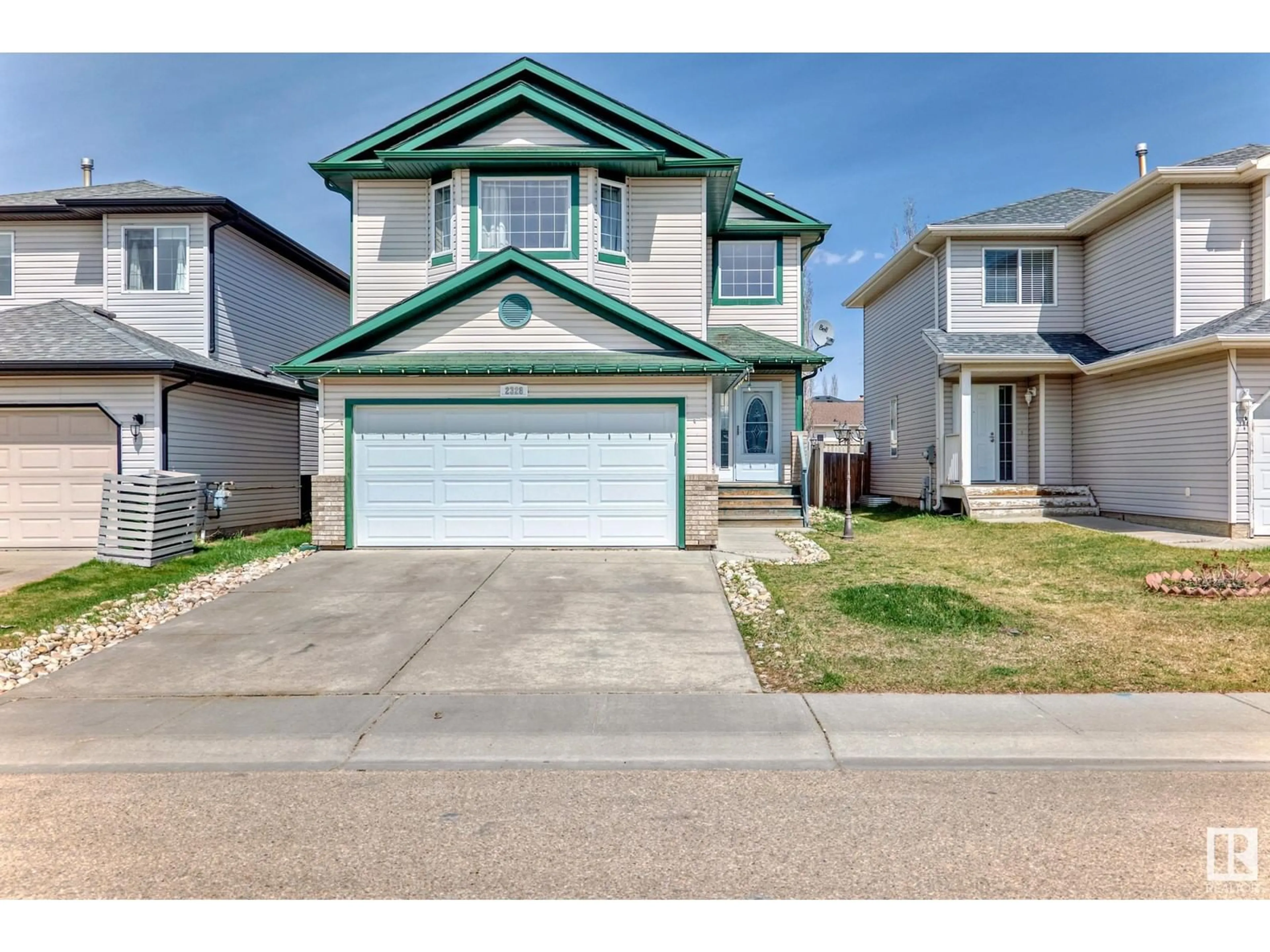 Home with vinyl exterior material, street for 2328 32 AV, Edmonton Alberta T6T1Z7