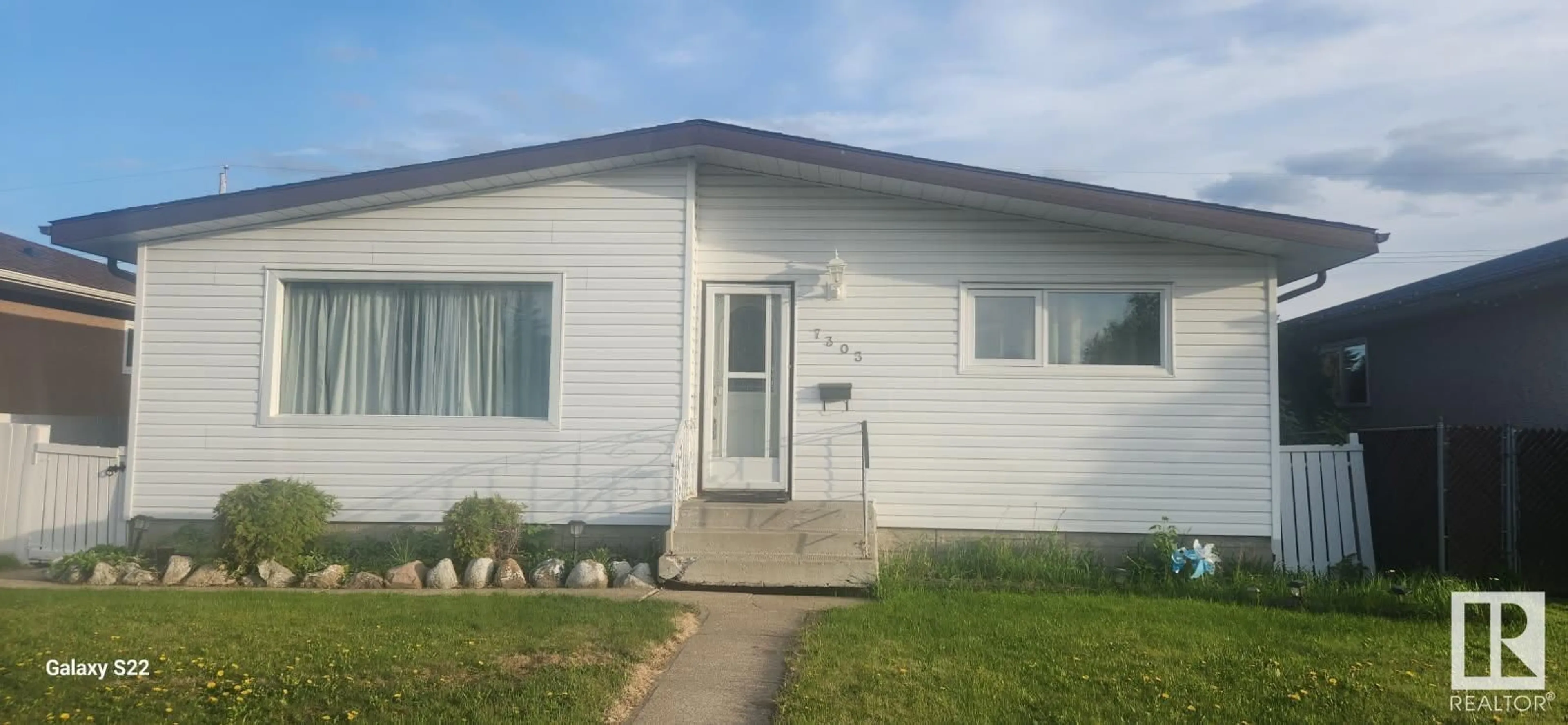 Home with vinyl exterior material, street for 7303 130 AV, Edmonton Alberta T5C1Y1