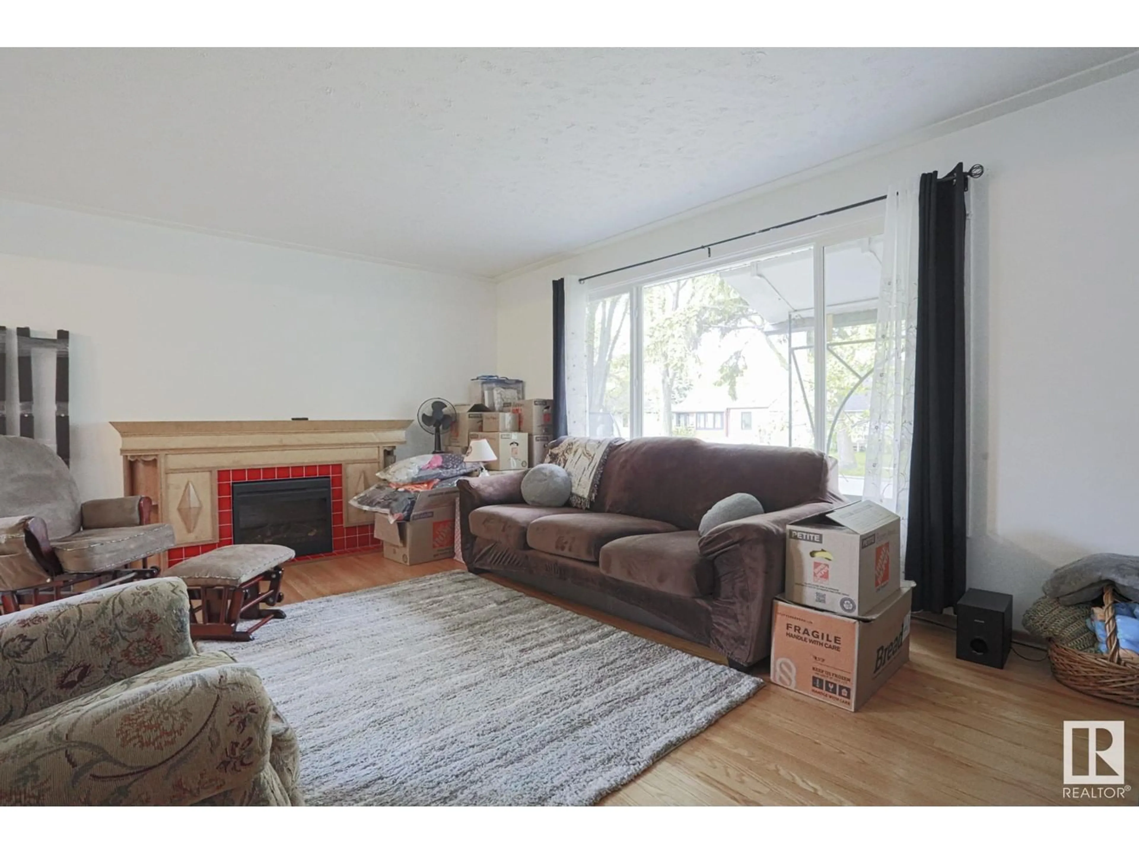 Living room with furniture, wood/laminate floor for NW - 12207 58 ST, Edmonton Alberta T5W3X6