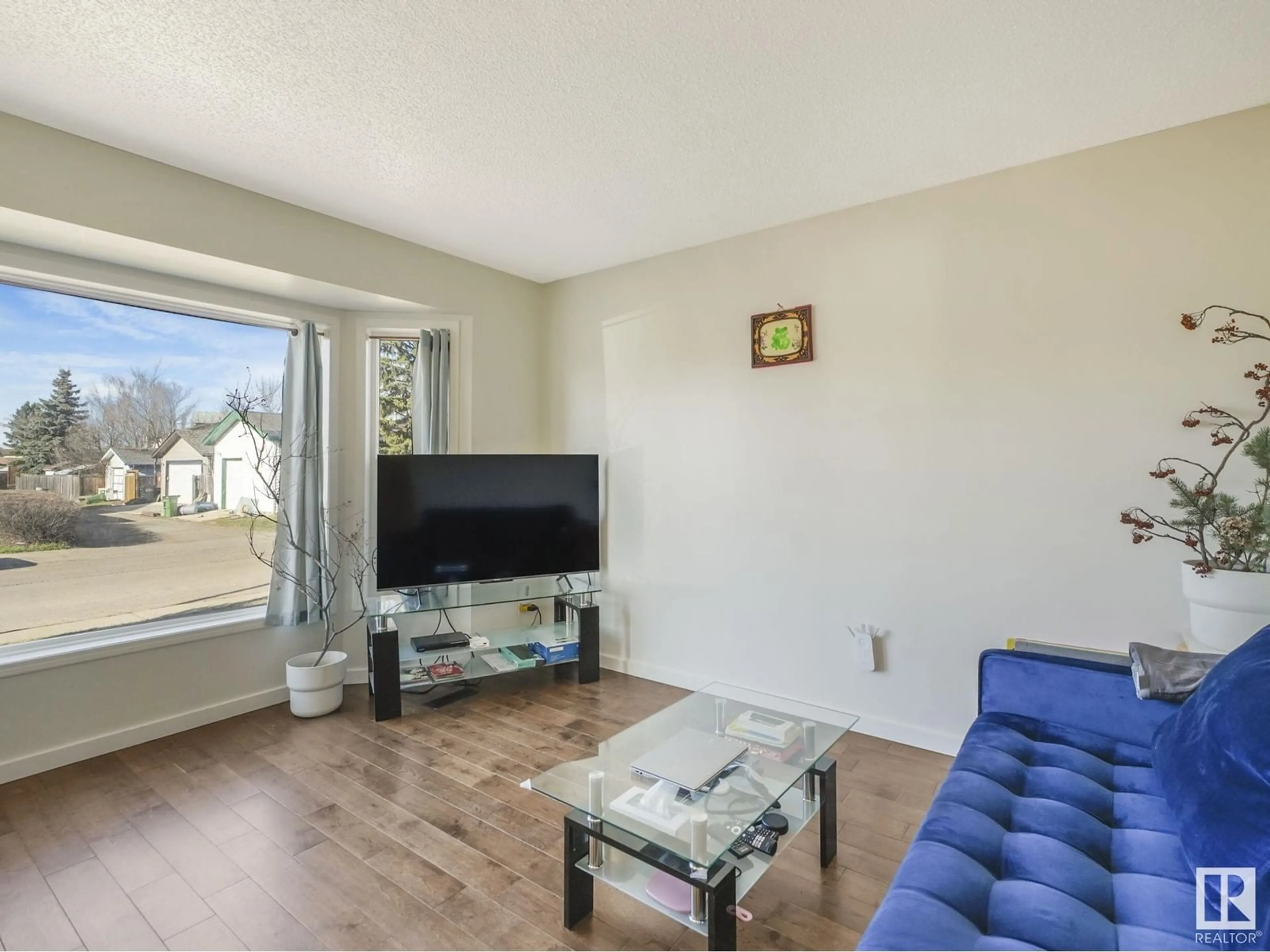 Living room with furniture, wood/laminate floor for 8337 156 AV, Edmonton Alberta T5Z2R5
