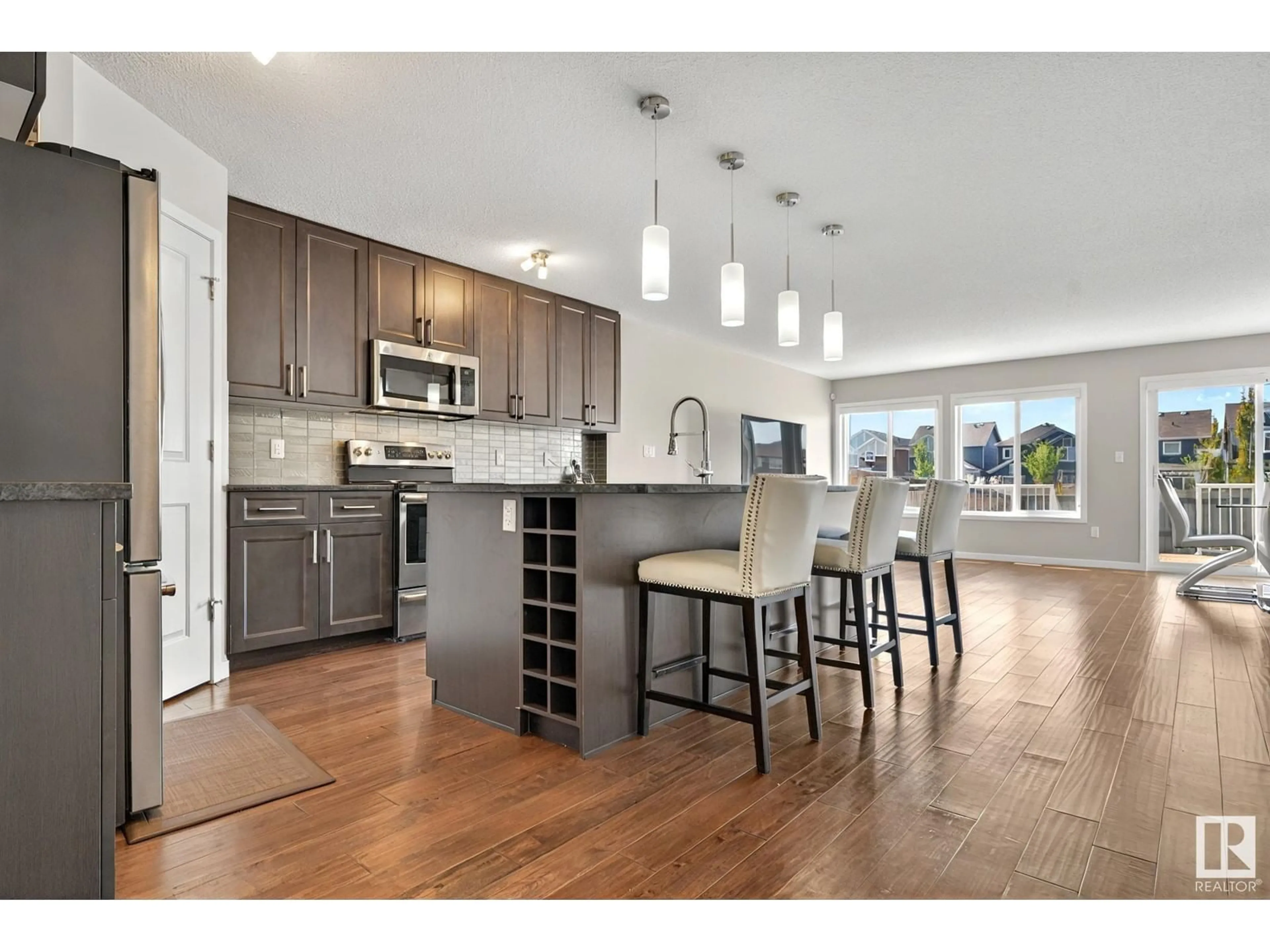 Open concept kitchen, wood/laminate floor for SW - 8233 24 AV, Edmonton Alberta T6X2J7