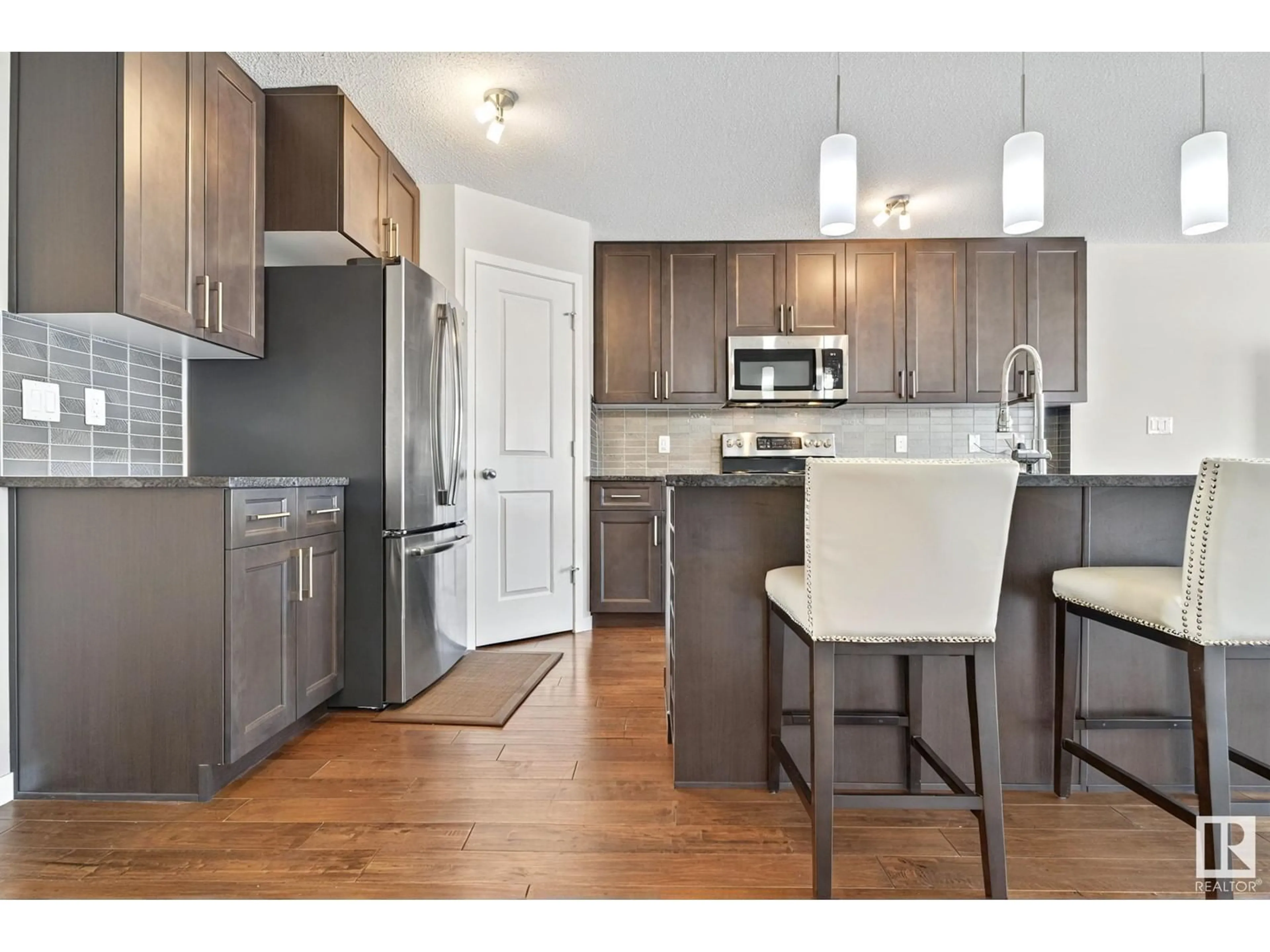 Open concept kitchen, wood/laminate floor for SW - 8233 24 AV, Edmonton Alberta T6X2J7