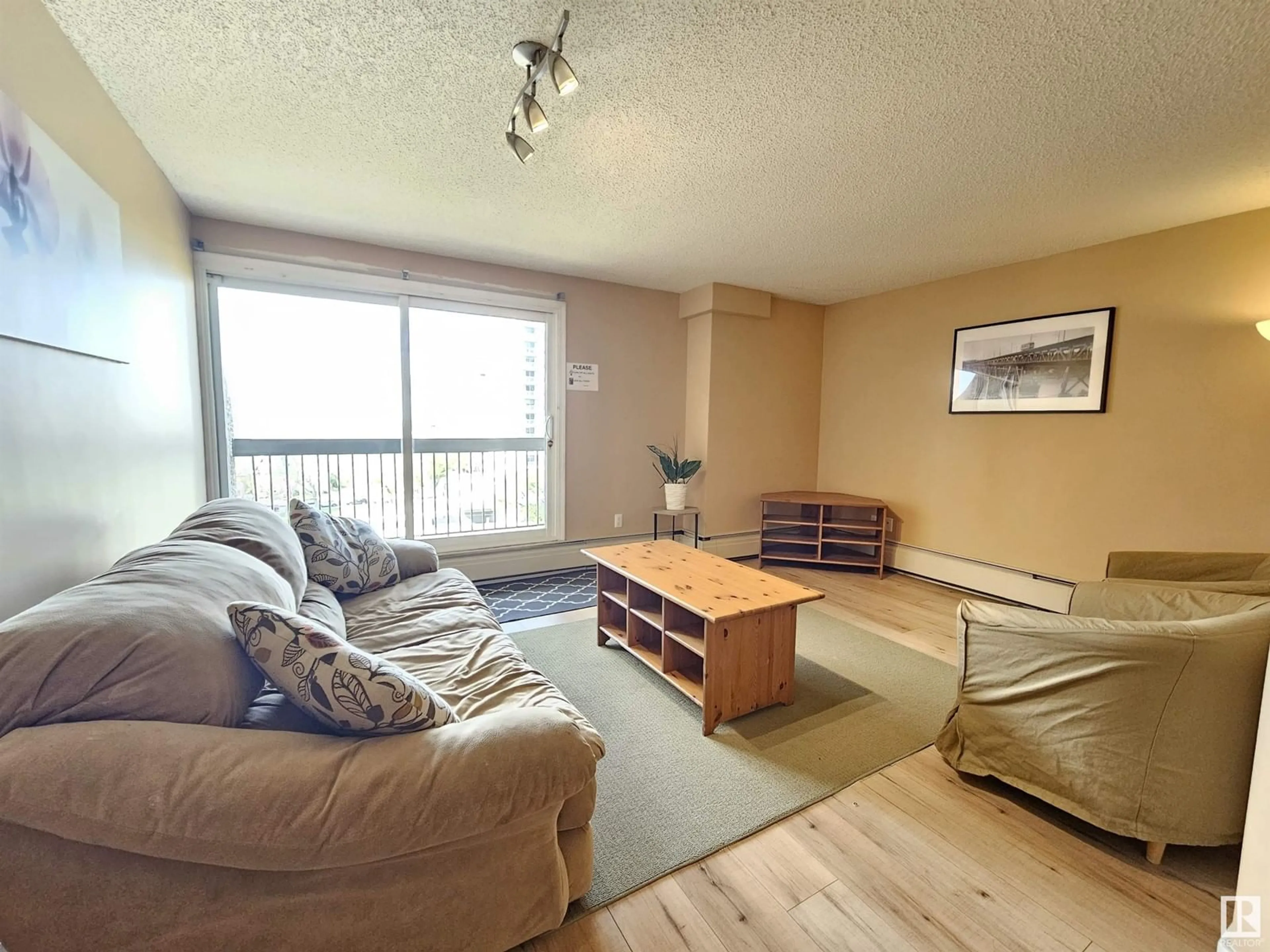 Living room with furniture, wood/laminate floor for 908 - 9715 110 ST, Edmonton Alberta T5K2M1