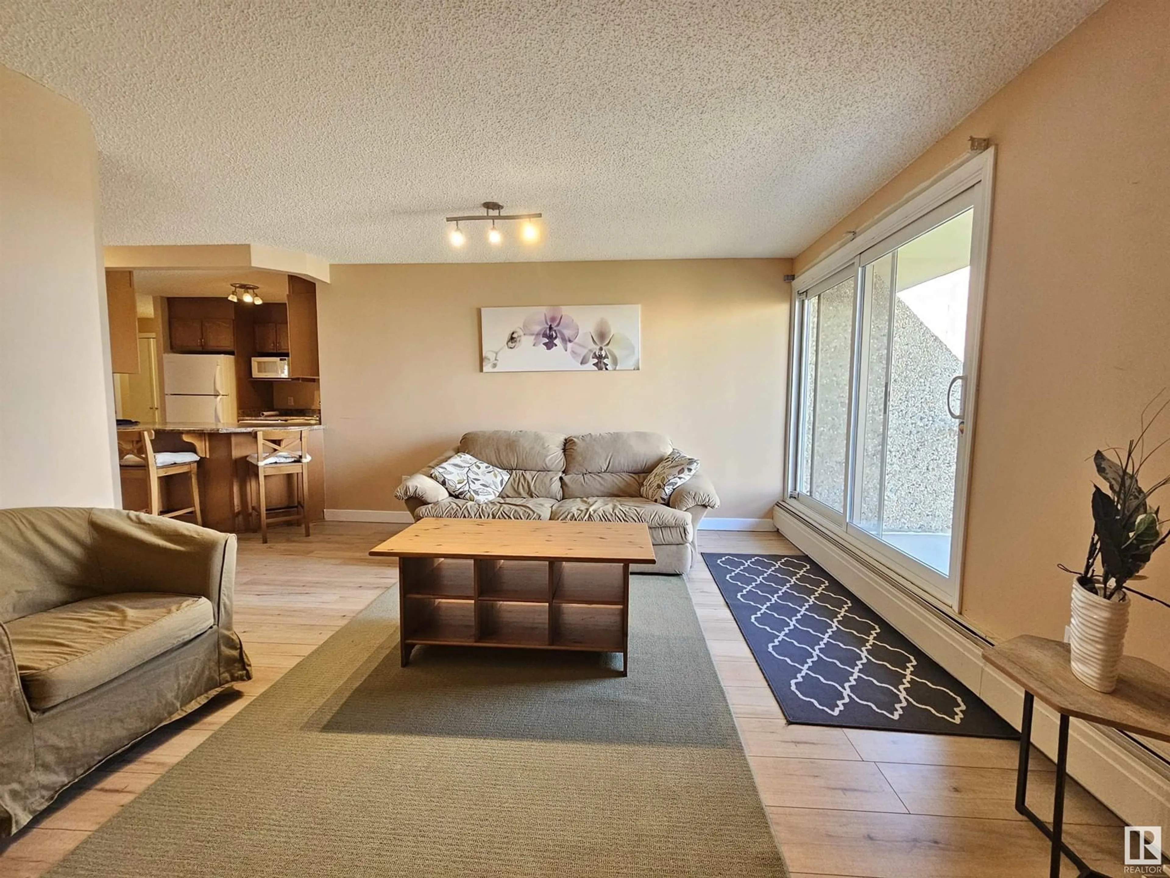 Living room with furniture, wood/laminate floor for 908 - 9715 110 ST, Edmonton Alberta T5K2M1
