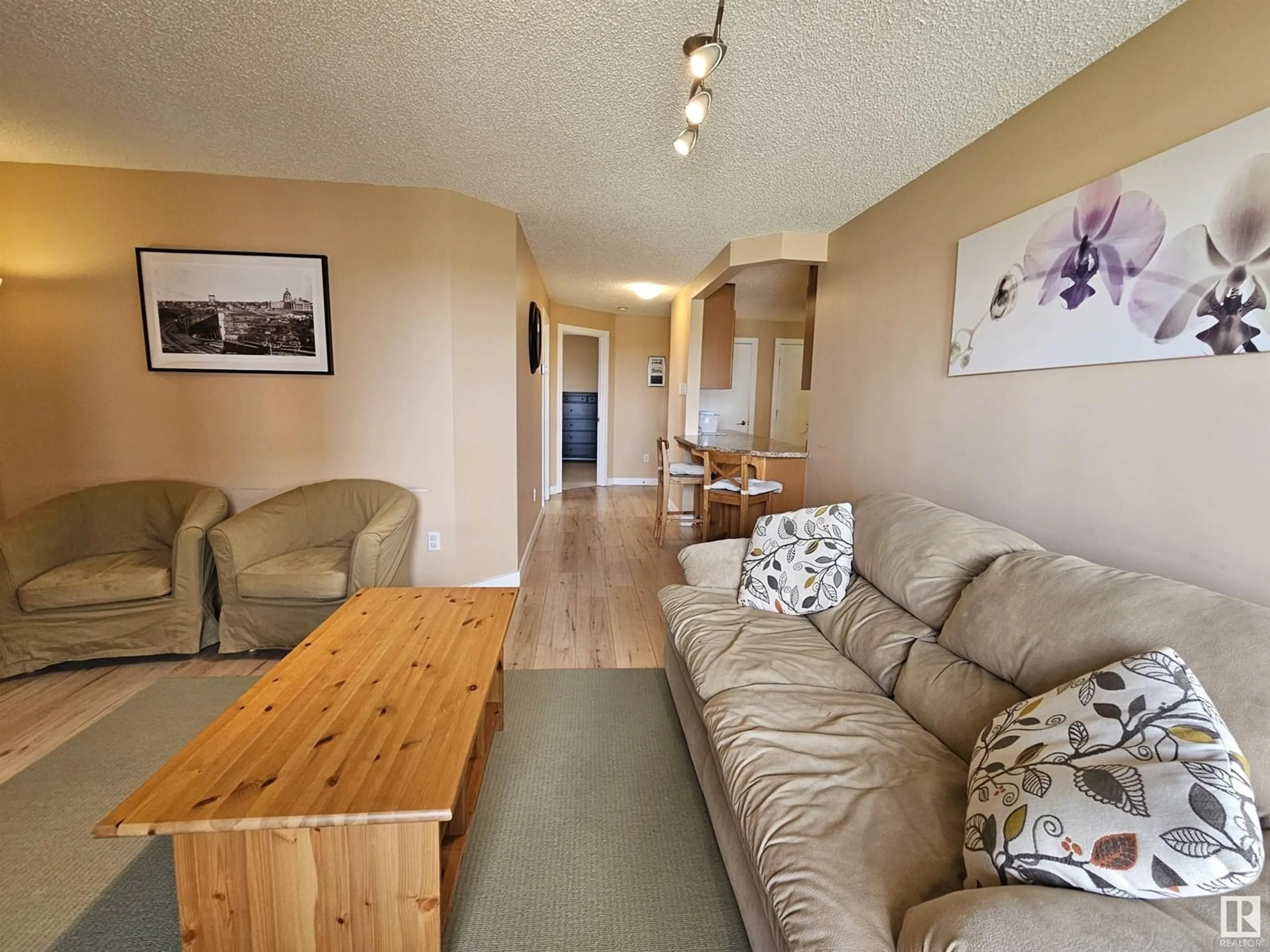 Living room with furniture, wood/laminate floor for 908 - 9715 110 ST, Edmonton Alberta T5K2M1