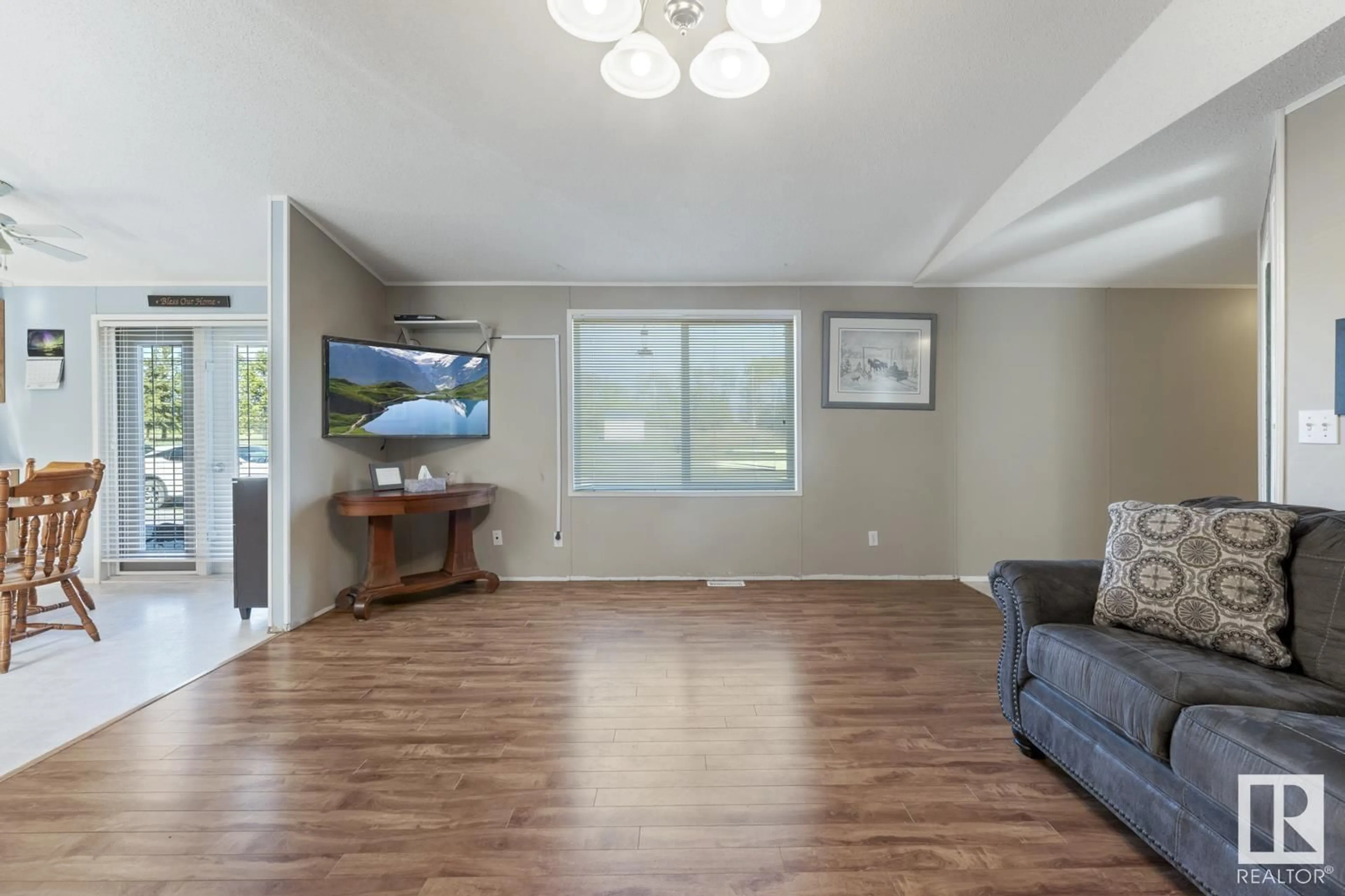 Living room with furniture, wood/laminate floor for 60313 657 HI, Rural Bonnyville M.D. Alberta T9N2J6