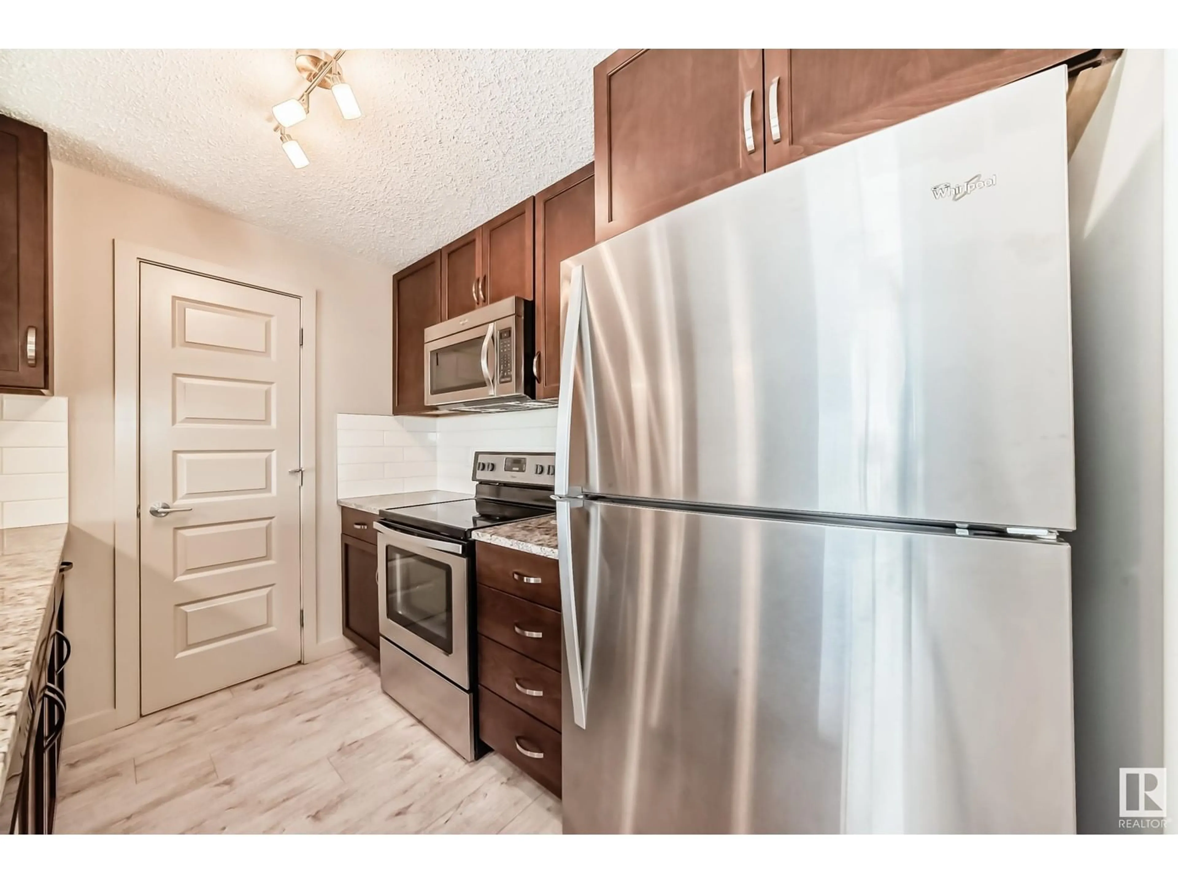 Standard kitchen, wood/laminate floor for #318 - 4008 SAVARYN DR, Edmonton Alberta T6X2E5