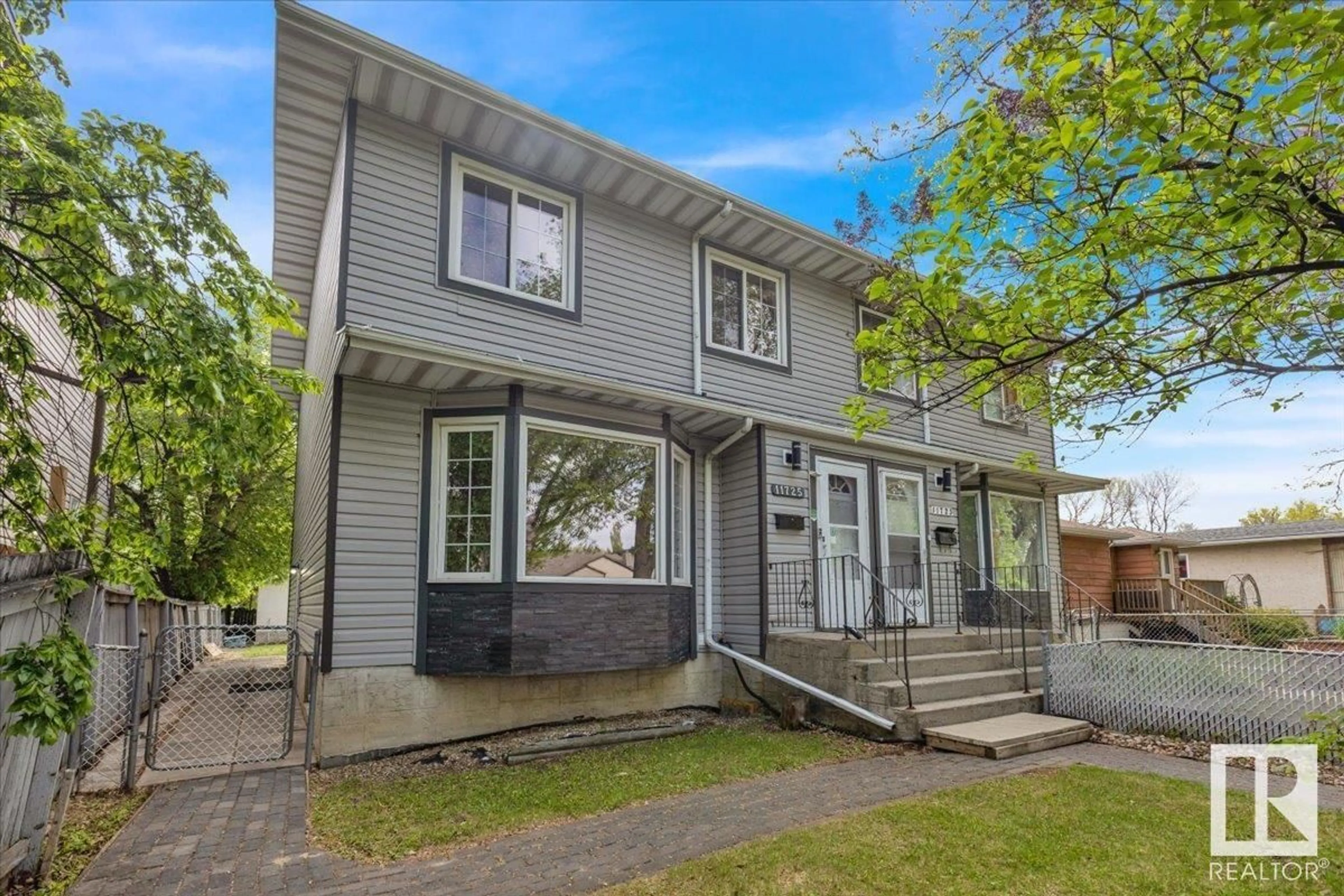Home with vinyl exterior material, street for 11725 125 ST, Edmonton Alberta T5M0N7