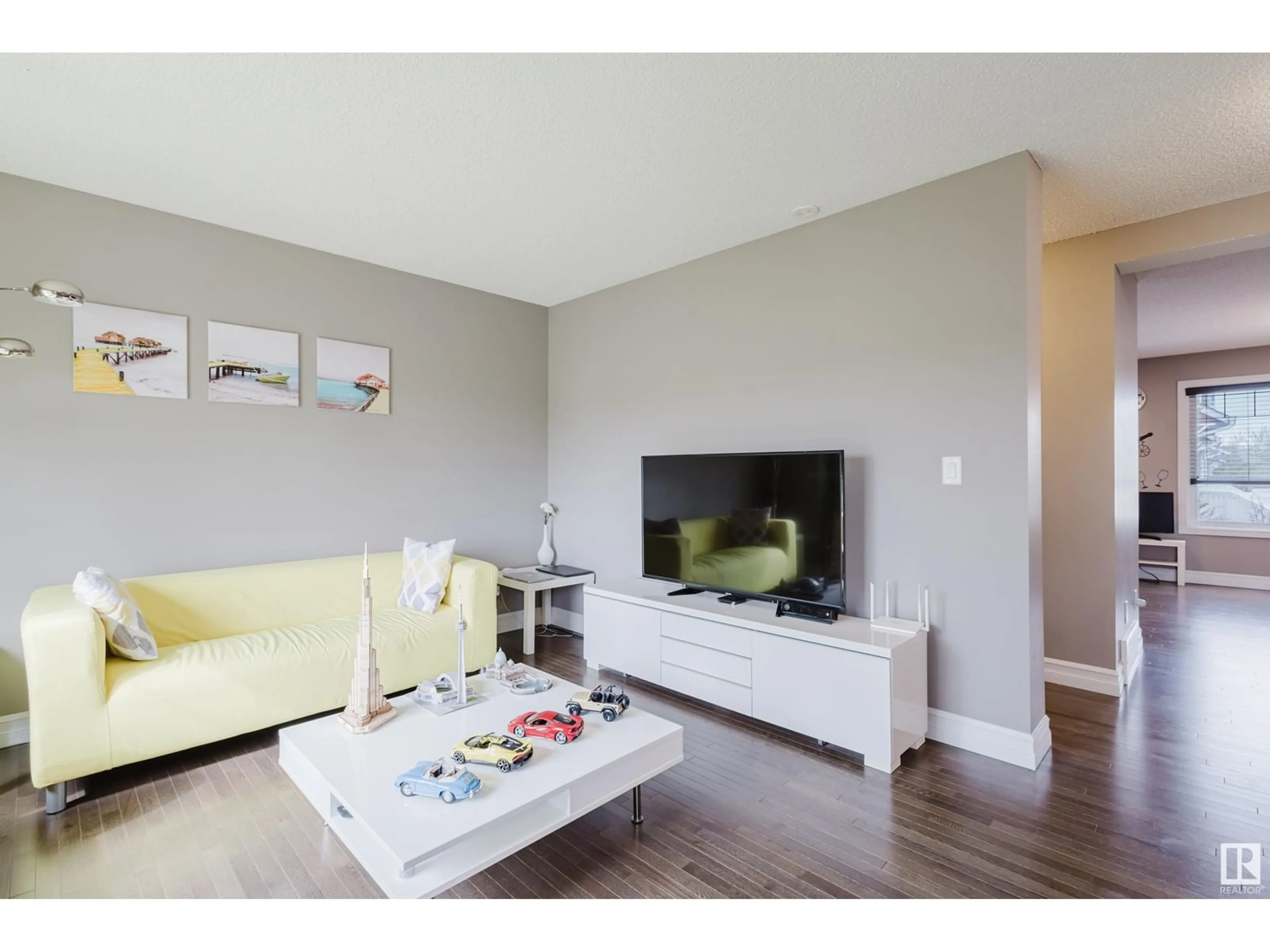 Living room with furniture, wood/laminate floor for #117 - 3625 144 AV, Edmonton Alberta T5Y0T3