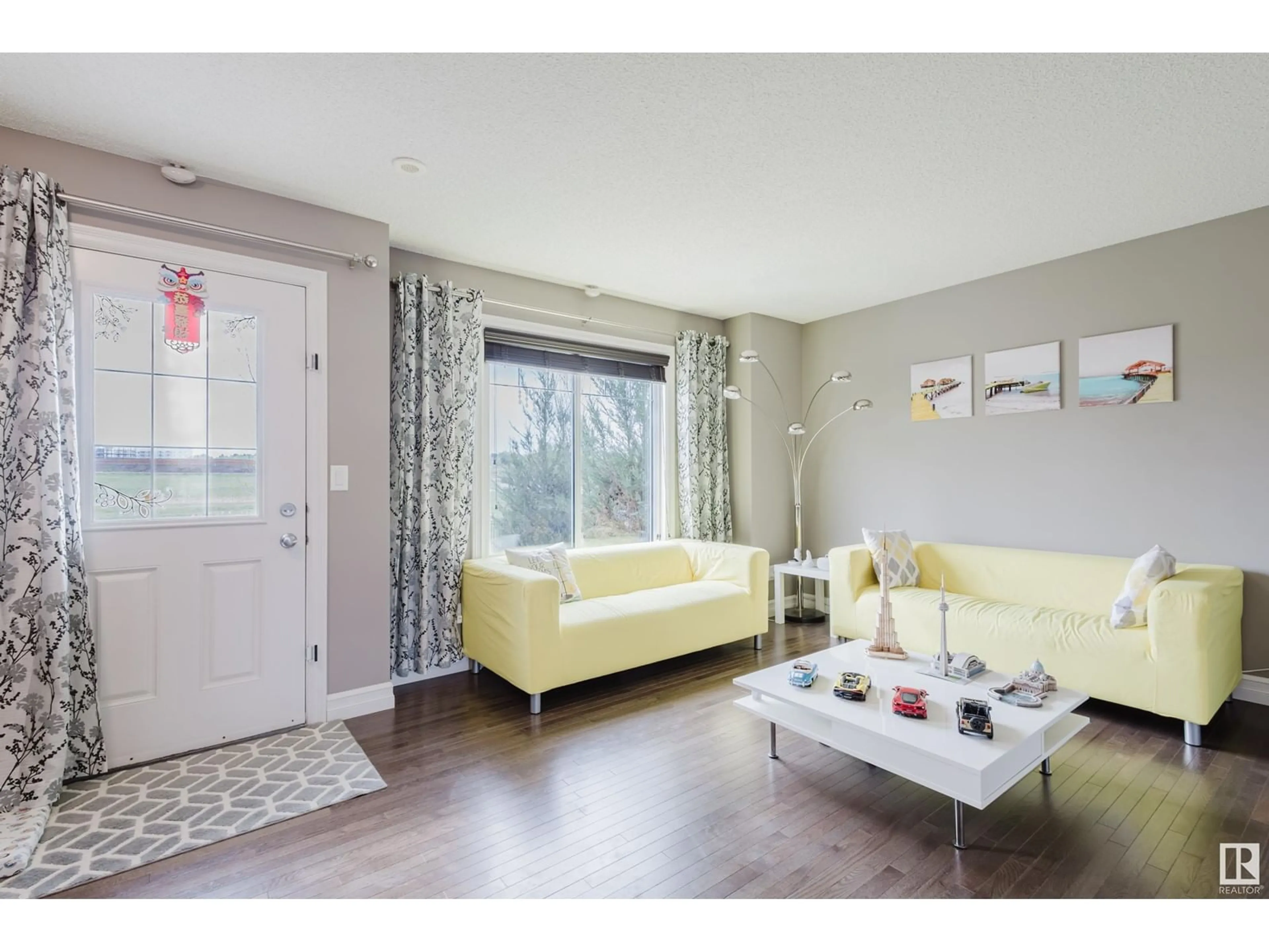 Living room with furniture, wood/laminate floor for #117 - 3625 144 AV, Edmonton Alberta T5Y0T3