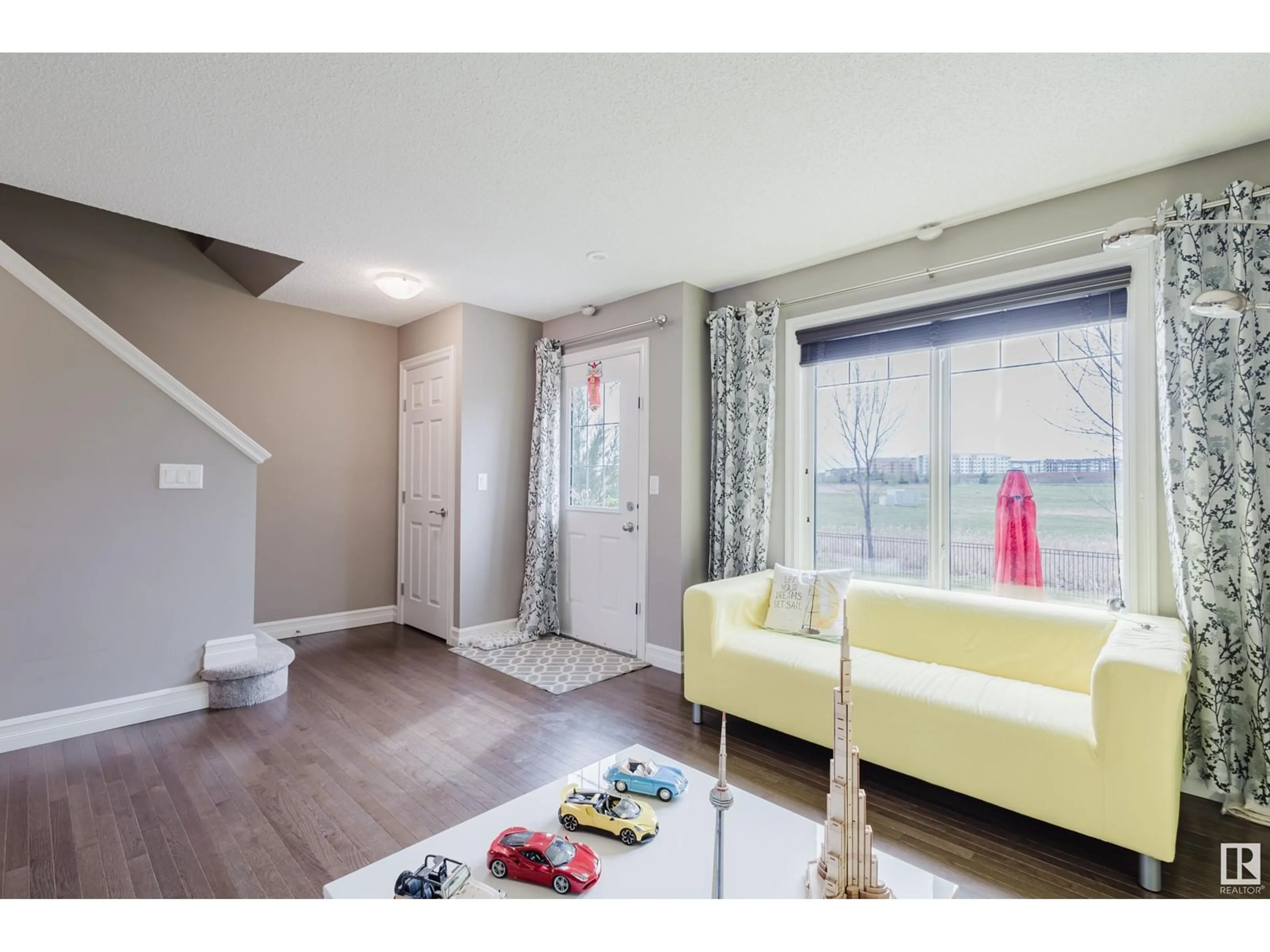 Living room with furniture, wood/laminate floor for #117 - 3625 144 AV, Edmonton Alberta T5Y0T3