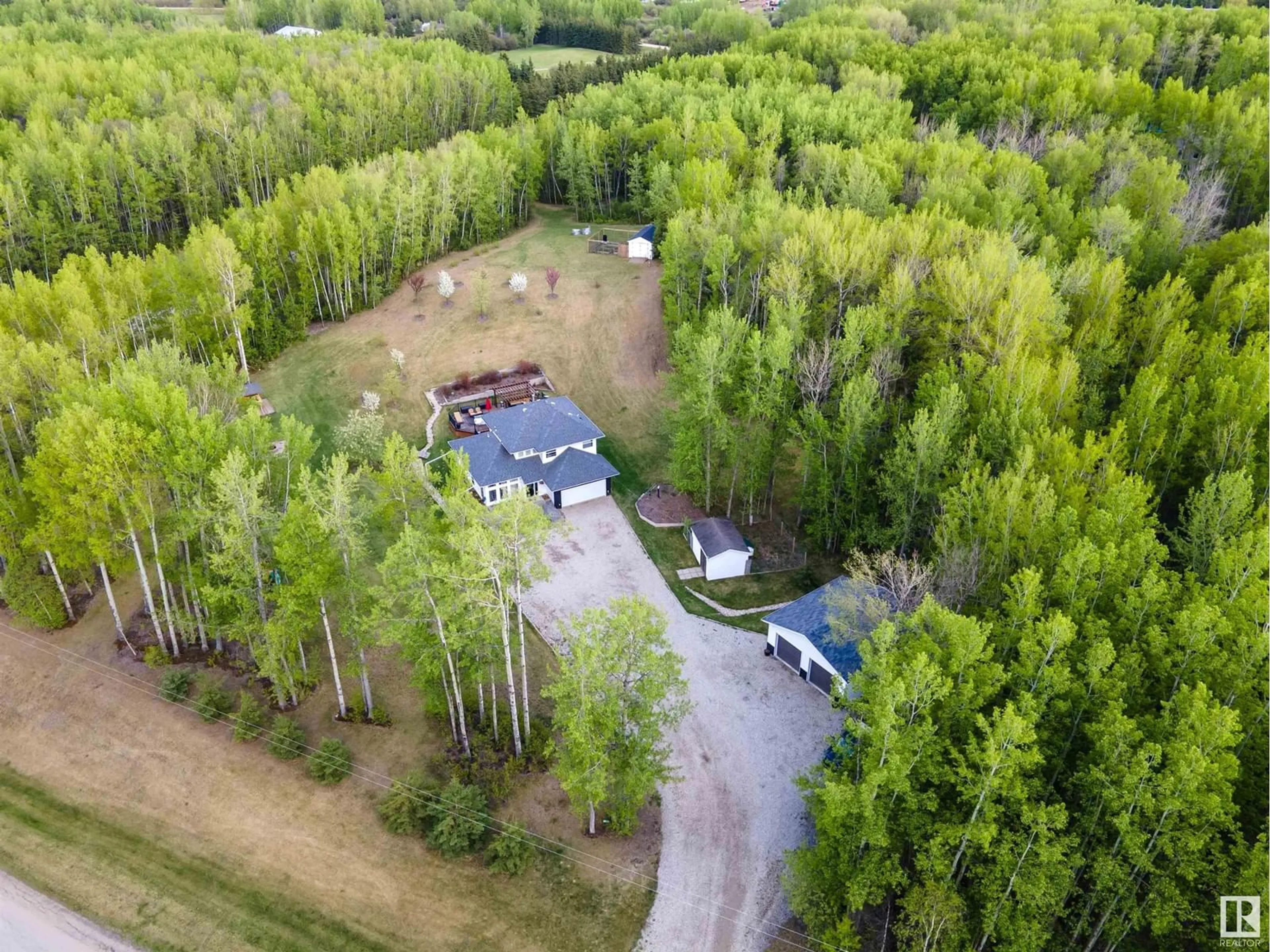 A pic from outside/outdoor area/front of a property/back of a property/a pic from drone, forest/trees view for 220 54130 RGE ROAD 12, Rural Parkland County Alberta T7Y0A5