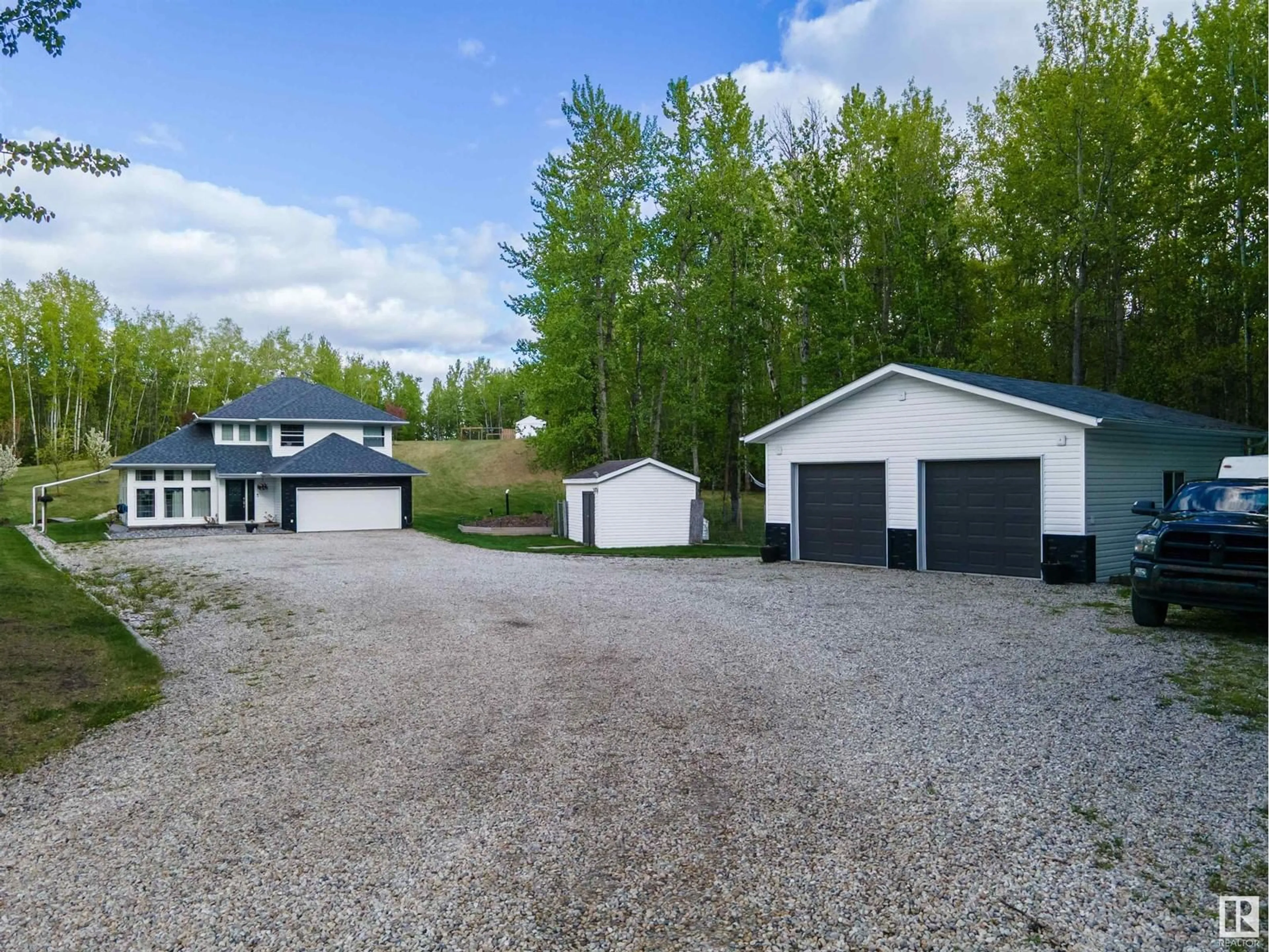 A pic from outside/outdoor area/front of a property/back of a property/a pic from drone, street for 220 54130 RGE ROAD 12, Rural Parkland County Alberta T7Y0A5