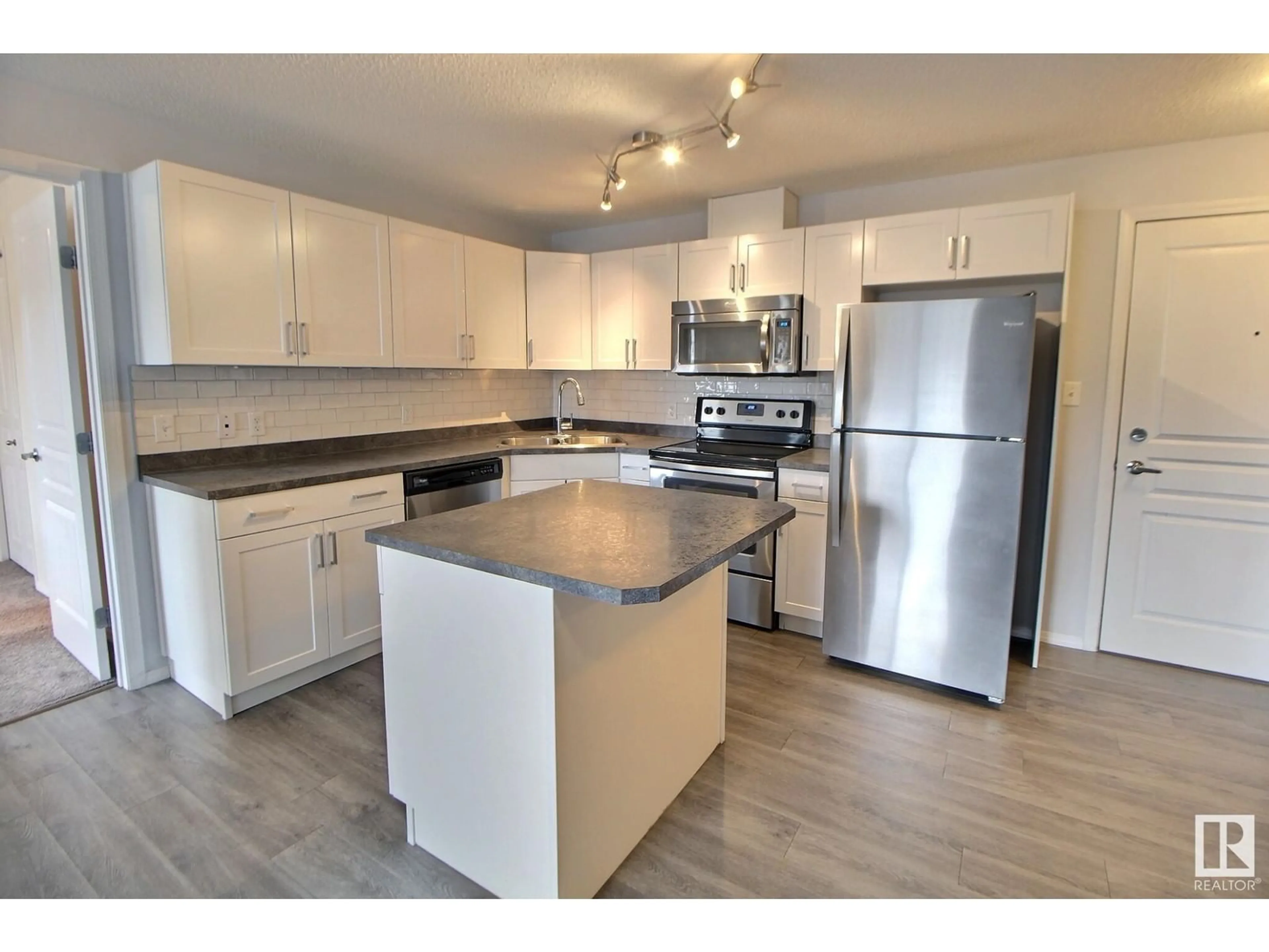 Open concept kitchen, wood/laminate floor for 301 - 340 CLAREVIEW STATION DR NW, Edmonton Alberta T5Y0J4