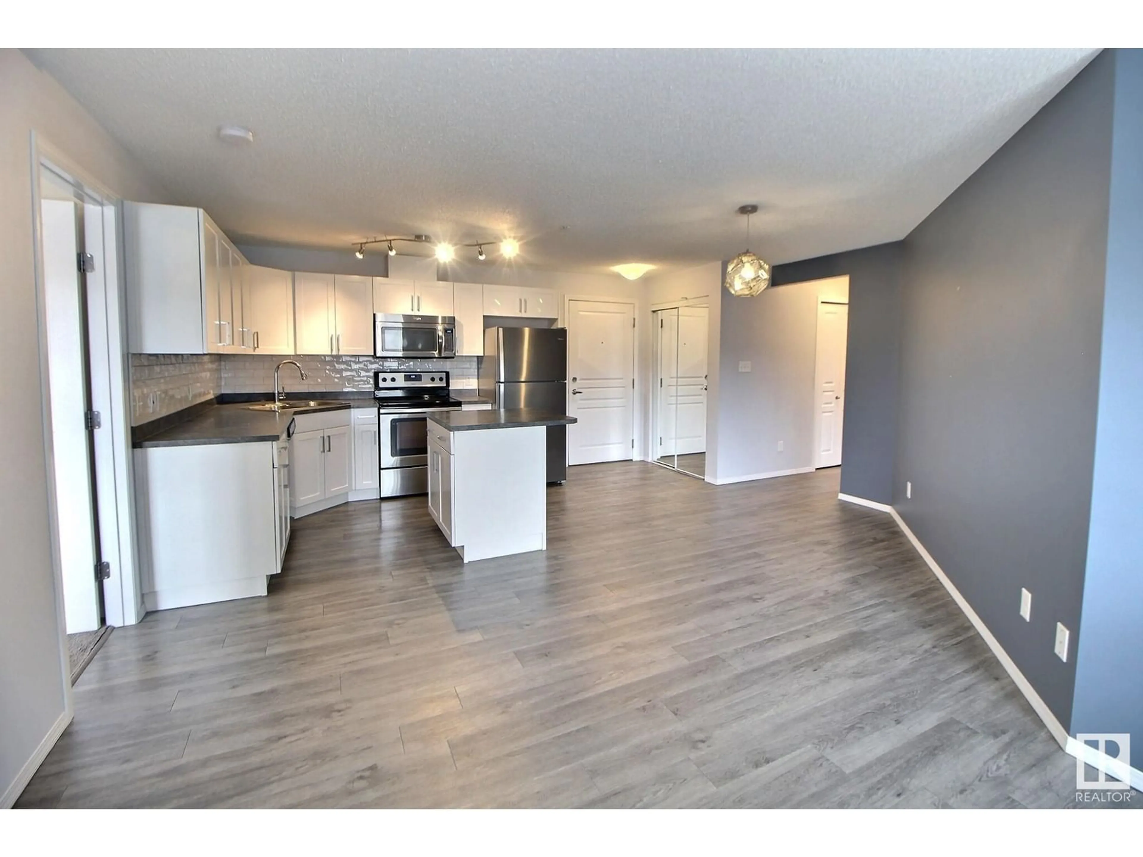 Open concept kitchen, wood/laminate floor for 301 - 340 CLAREVIEW STATION DR NW, Edmonton Alberta T5Y0J4