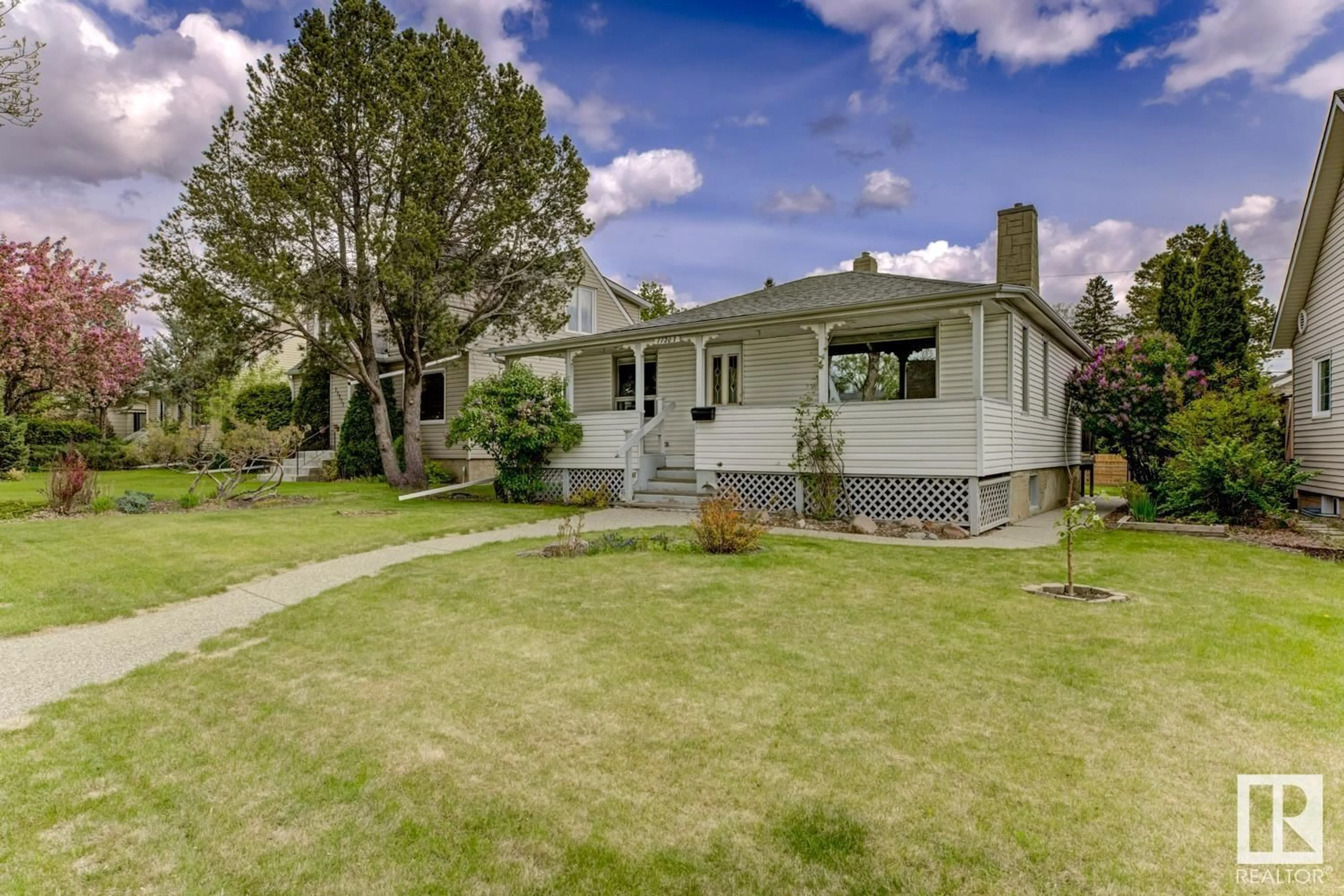 Home with vinyl exterior material, street for NW - 11207 57 ST, Edmonton Alberta T5W3V1