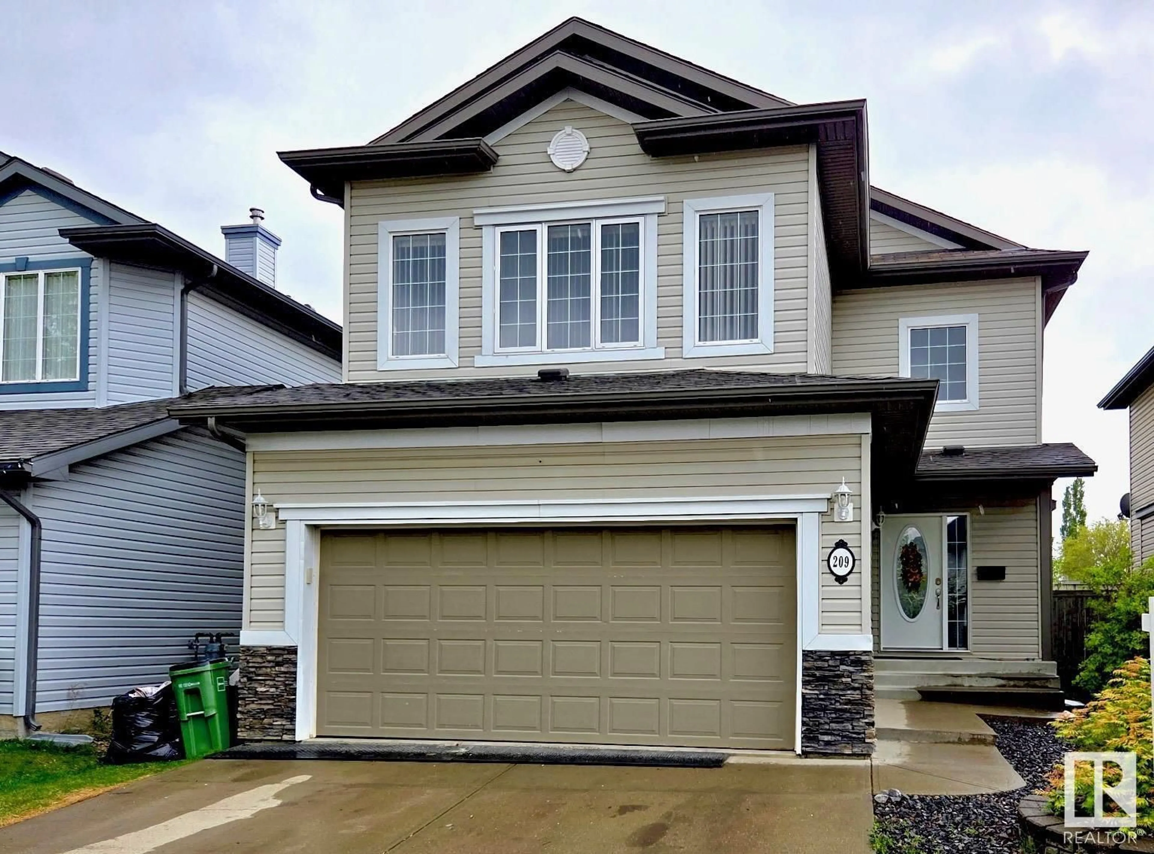 Home with vinyl exterior material, street for 209 MACEWAN RD, Edmonton Alberta T6W1R2