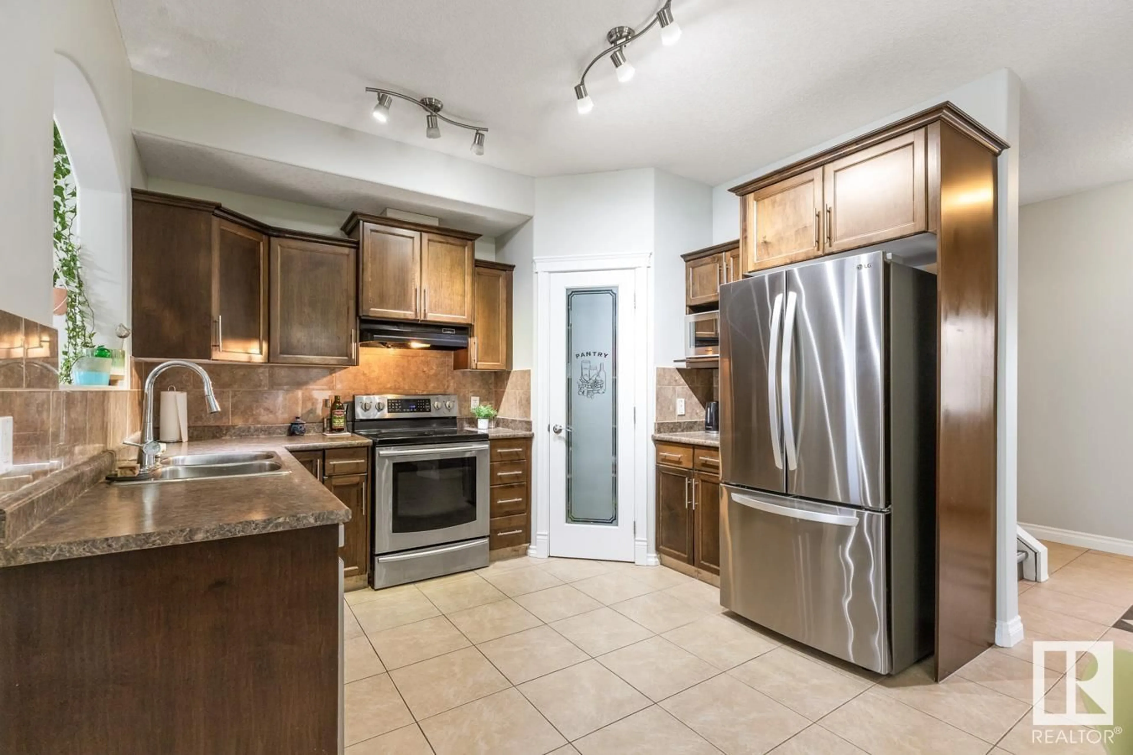 Open concept kitchen, ceramic/tile floor for 16405 53 ST, Edmonton Alberta T5Y0H5