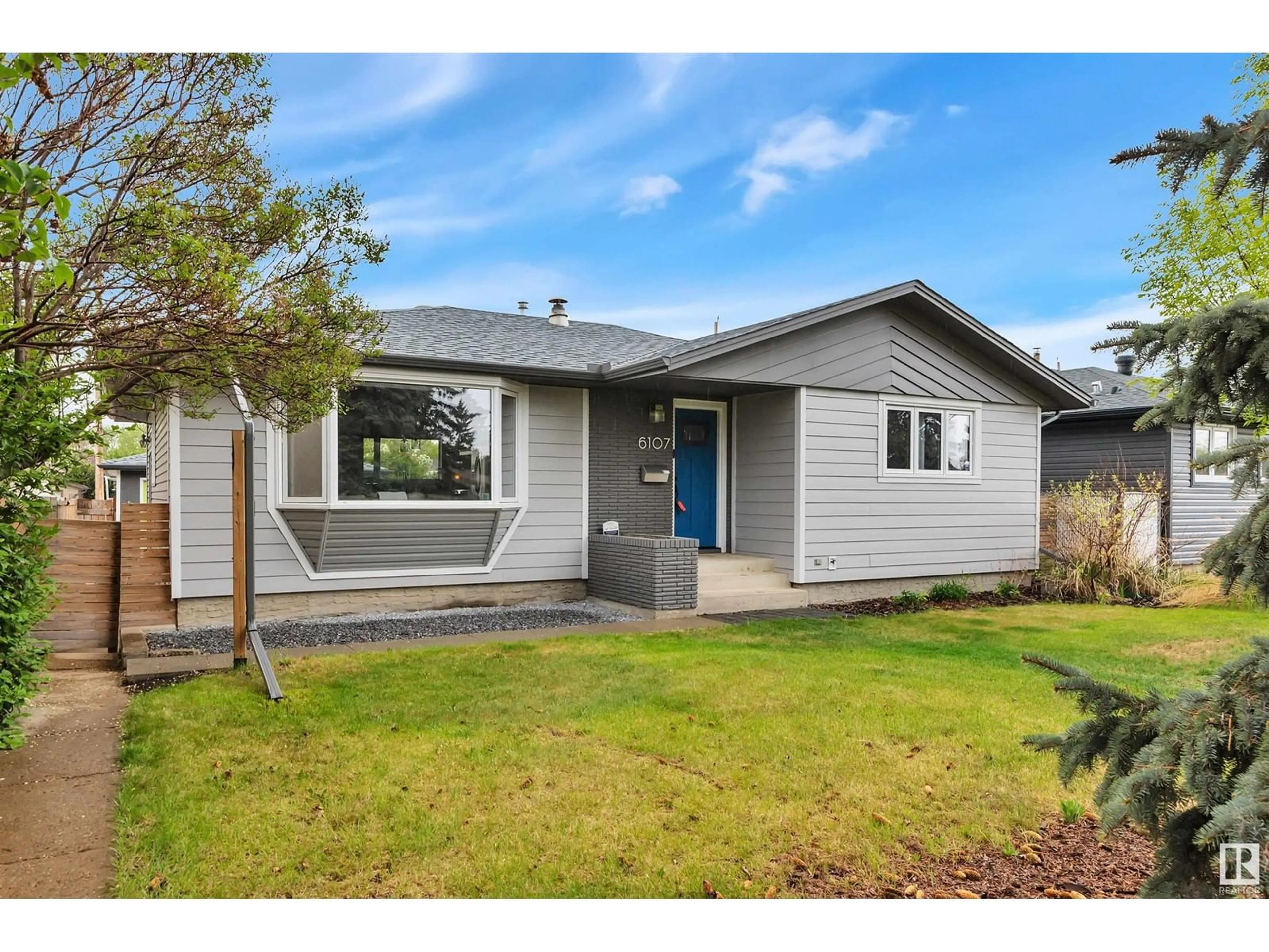 Home with vinyl exterior material, street for 6107 85 AV, Edmonton Alberta T6B0J4