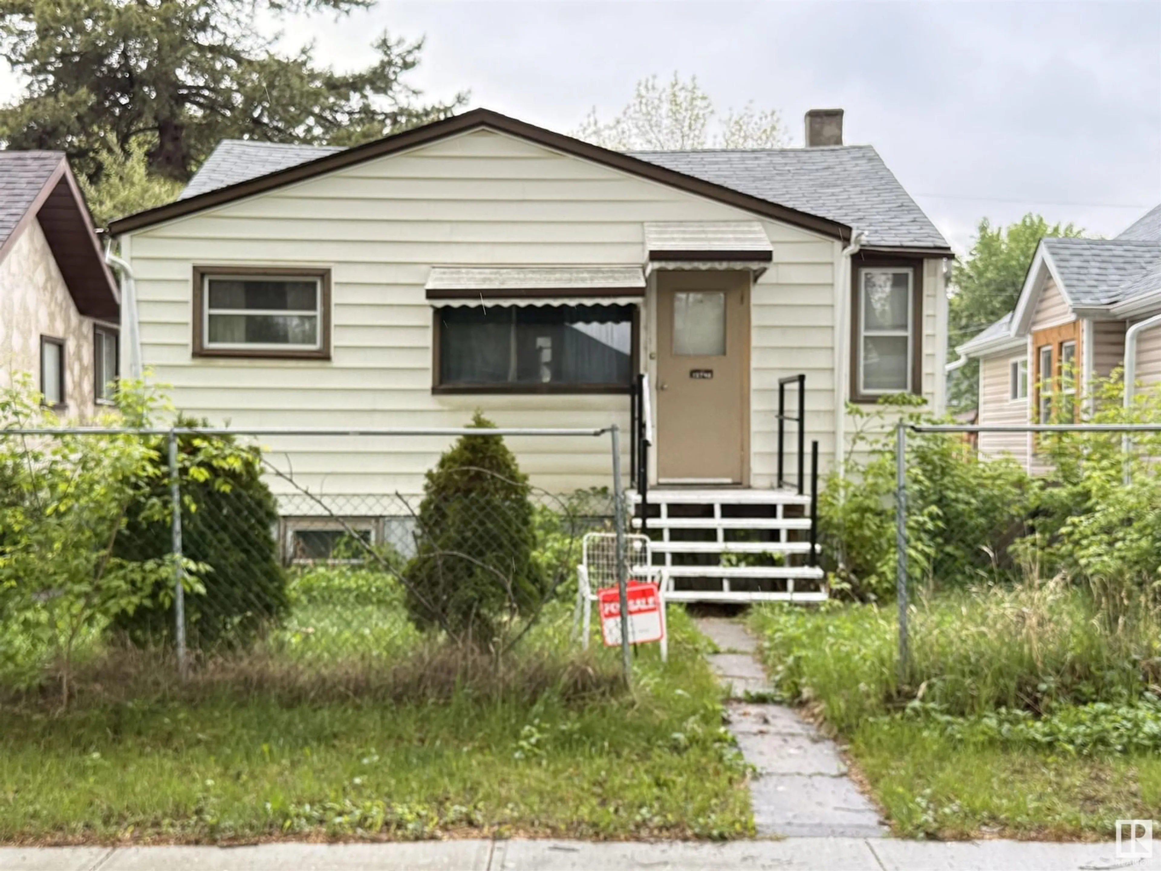 Home with vinyl exterior material, street for NW - 12746 116 ST, Edmonton Alberta T5E5H2