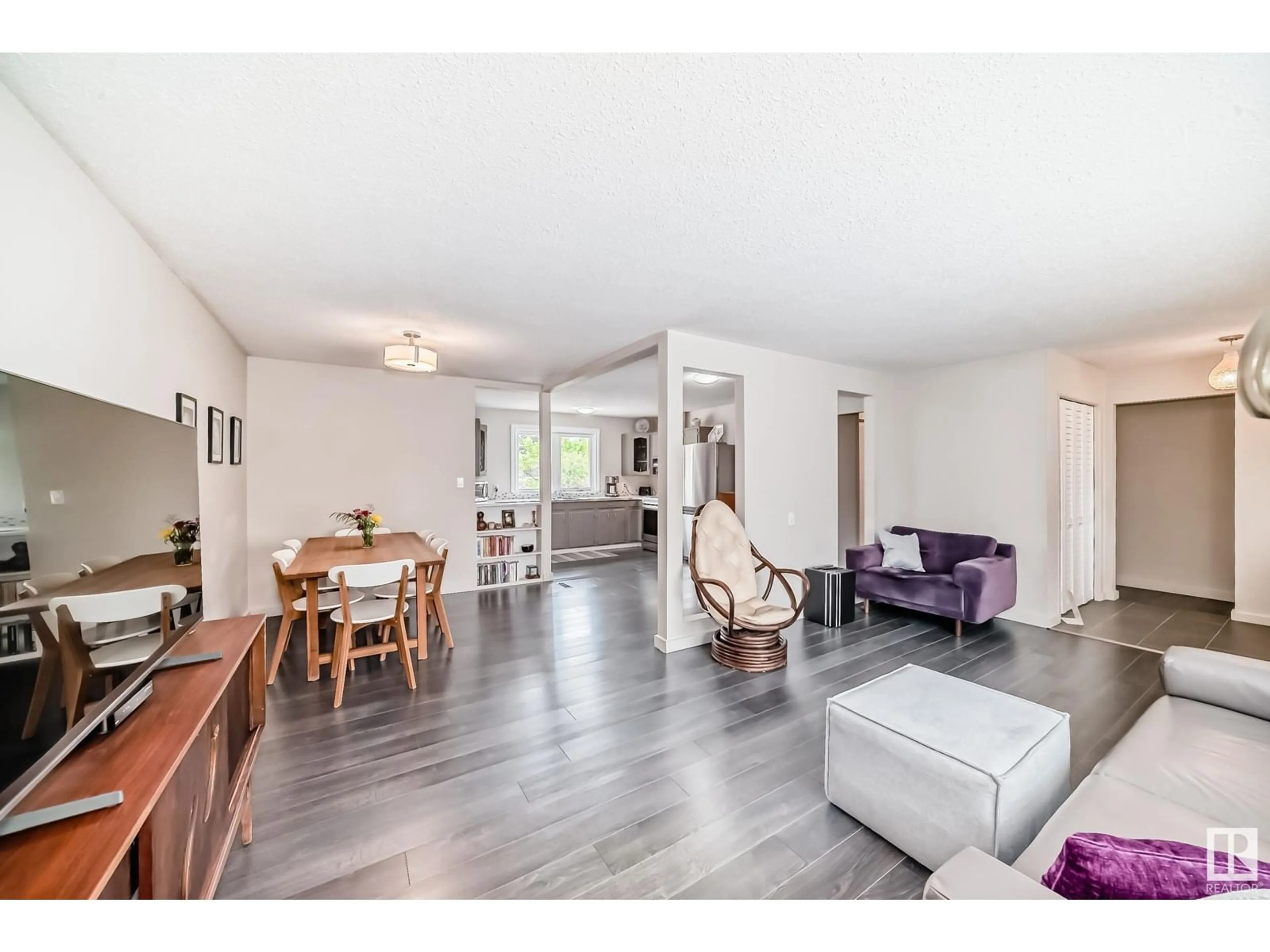 Living room with furniture, wood/laminate floor for 10439 37 AV, Edmonton Alberta T6K2H9