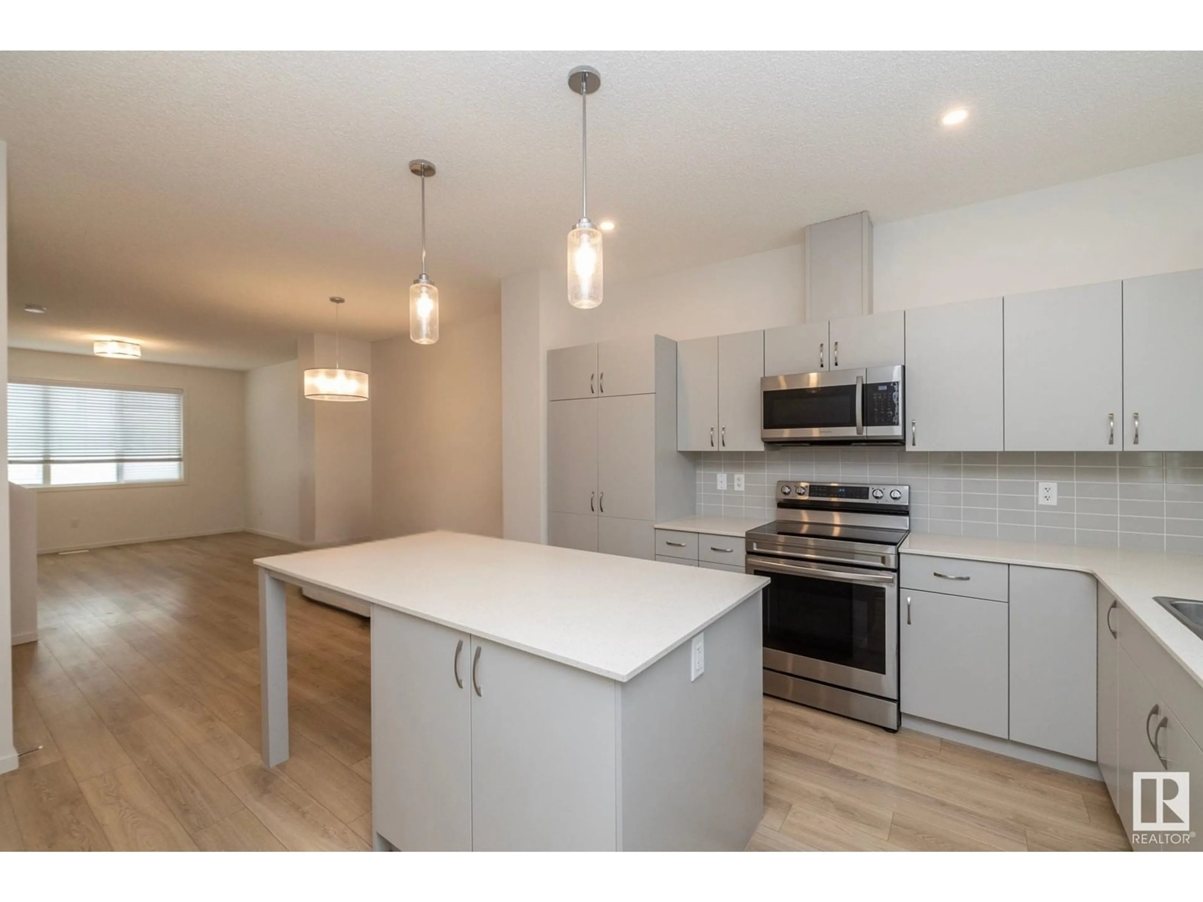 Open concept kitchen, wood/laminate floor for 1279 ROSENTHAL BV, Edmonton Alberta T5T7N7