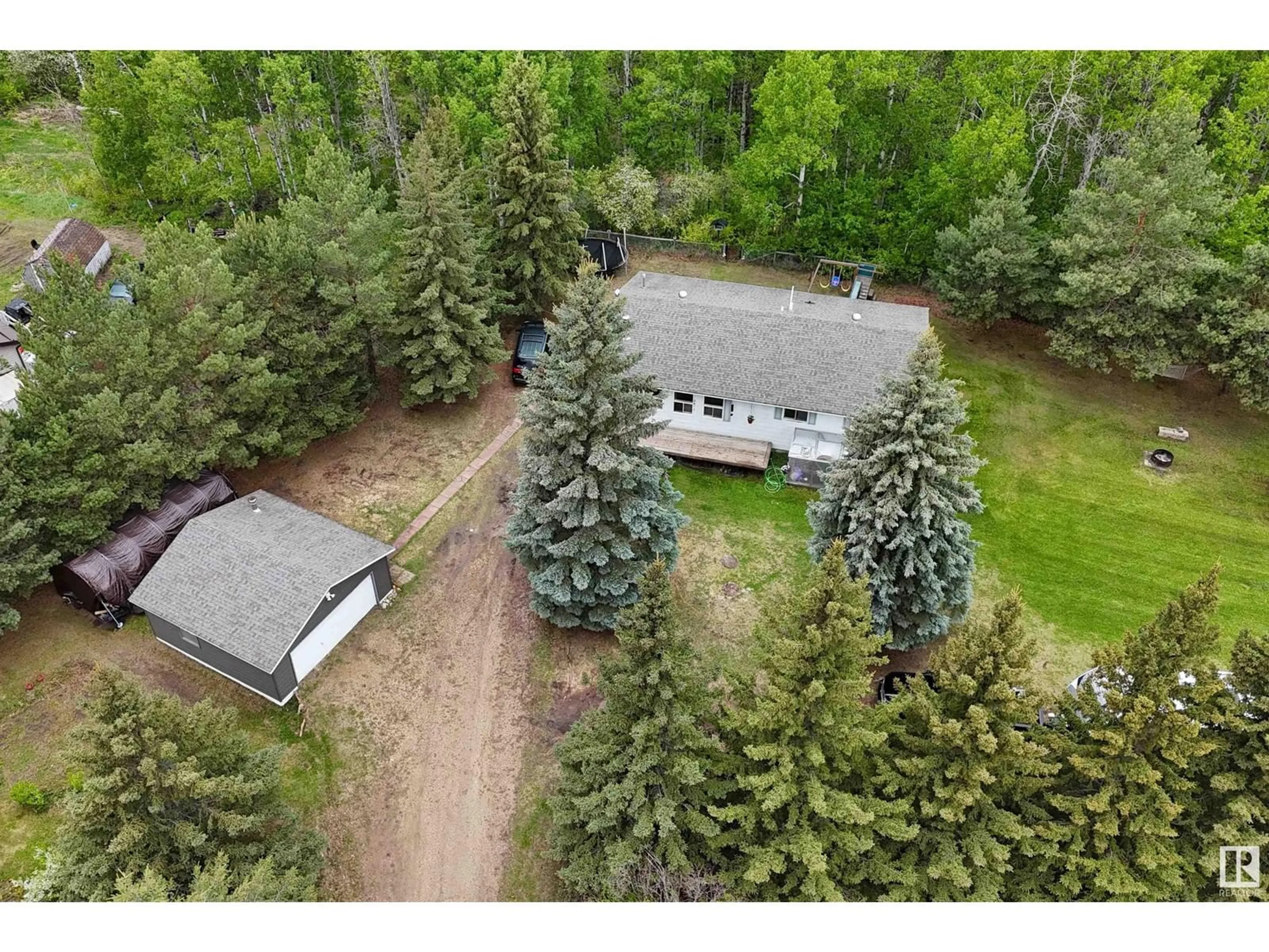 A pic from outside/outdoor area/front of a property/back of a property/a pic from drone, forest/trees view for #6 - 2311 TWP ROAD 530, Rural Parkland County Alberta T7Y3M8