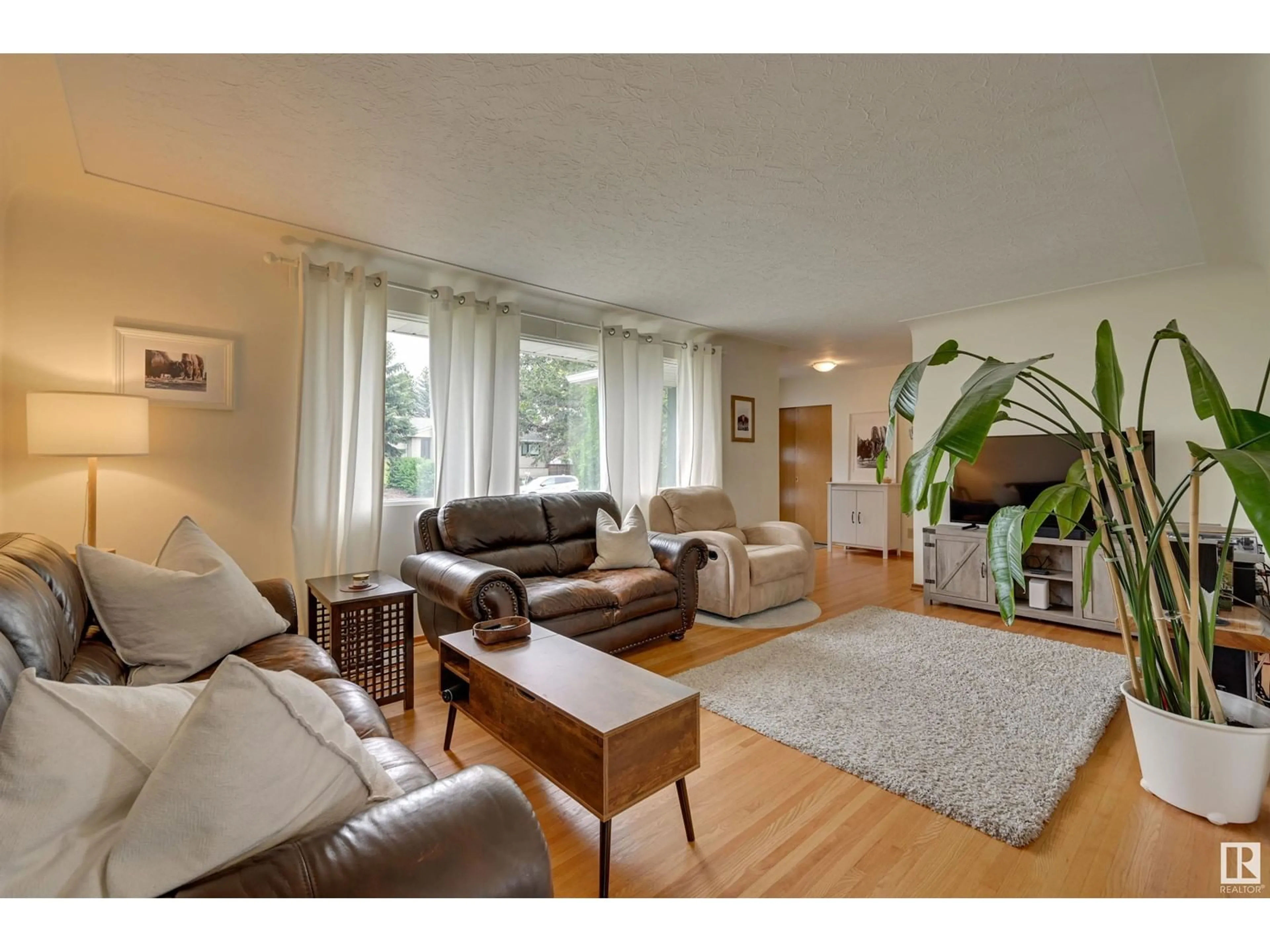 Living room with furniture, wood/laminate floor for 14407 88 AV, Edmonton Alberta T5R4J5