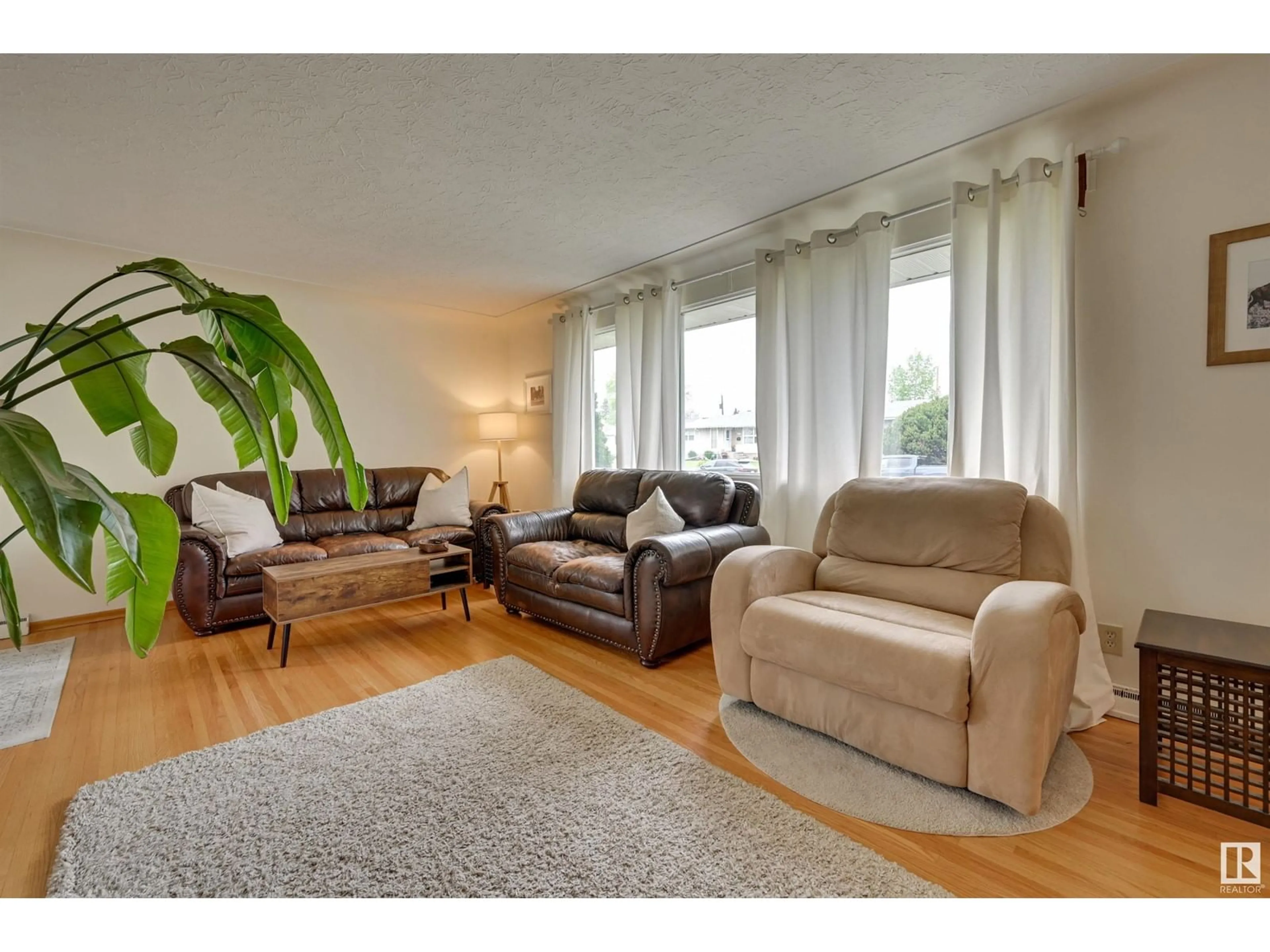 Living room with furniture, wood/laminate floor for 14407 88 AV, Edmonton Alberta T5R4J5