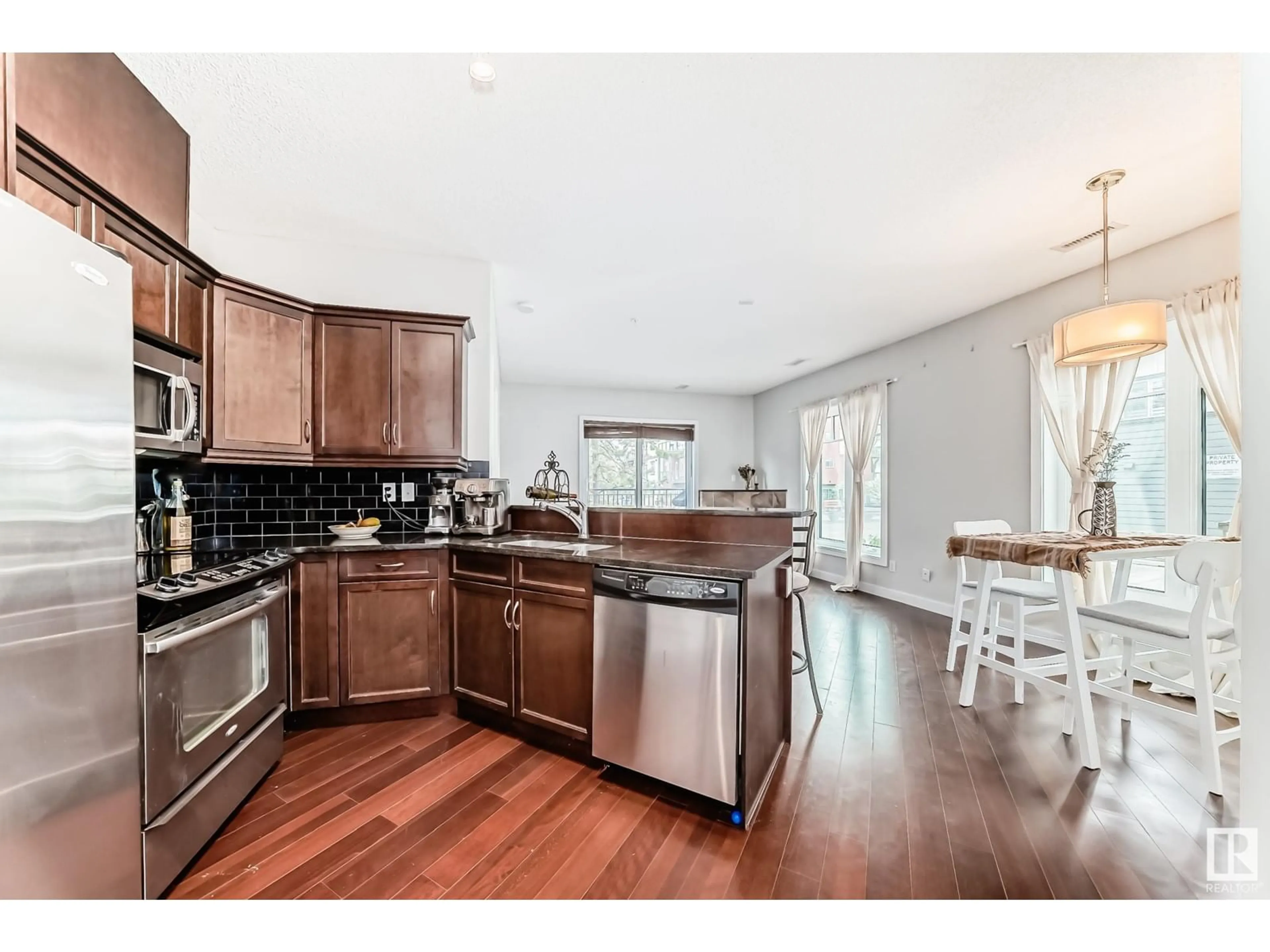 Open concept kitchen, wood/laminate floor for #102 - 7907 109 ST, Edmonton Alberta T6G1C7
