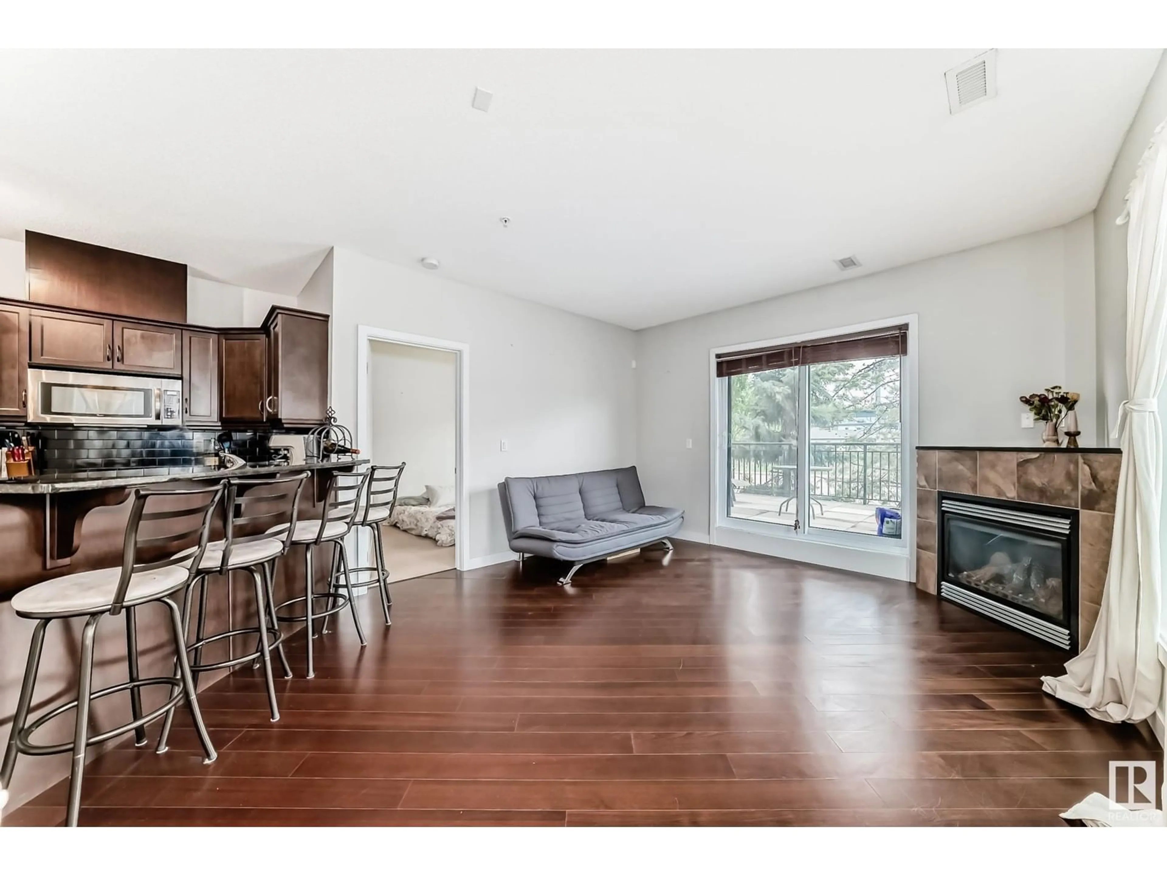 Open concept kitchen, wood/laminate floor for #102 - 7907 109 ST, Edmonton Alberta T6G1C7