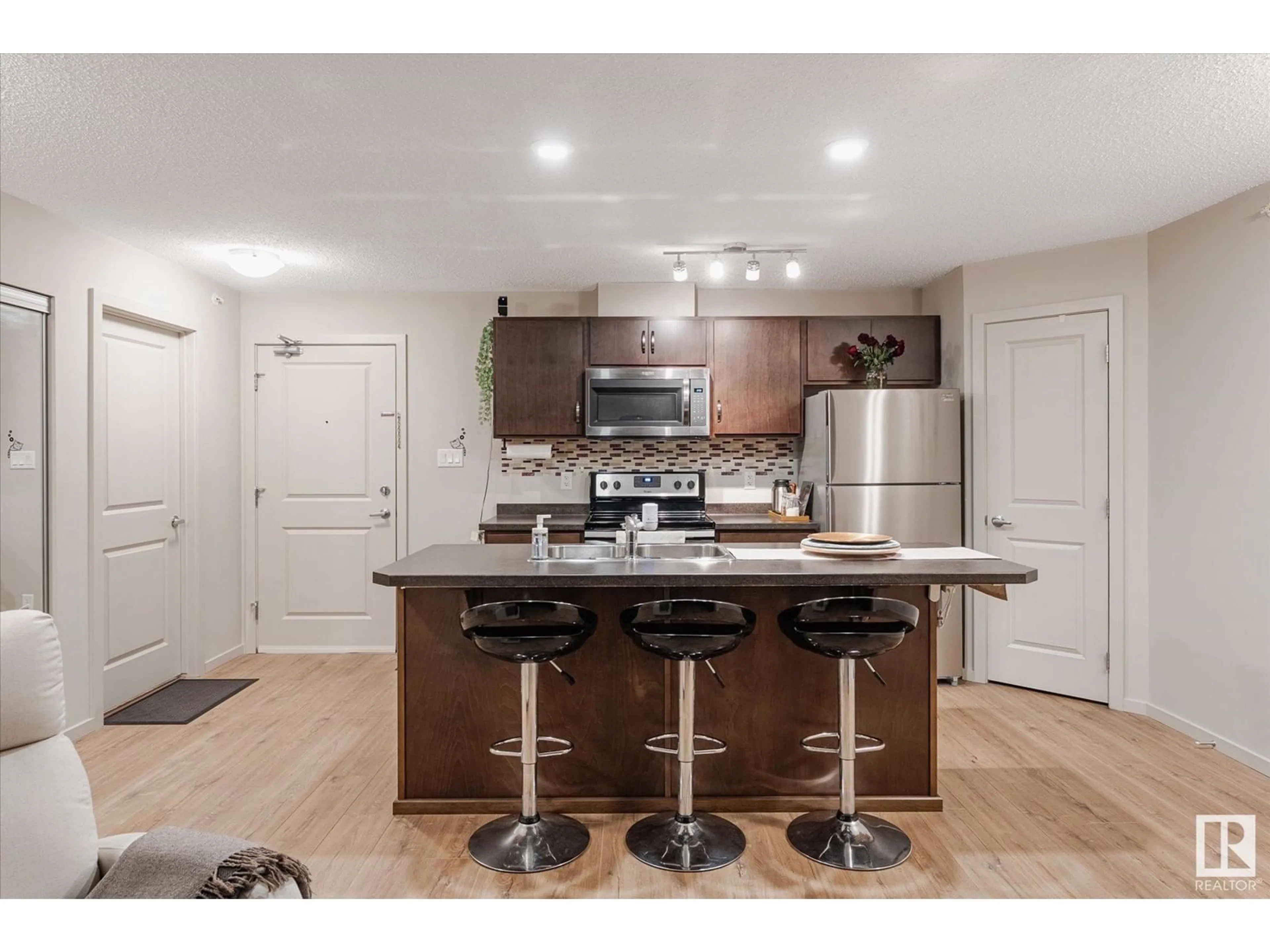 Open concept kitchen, wood/laminate floor for 405 - 5404 7 AV, Edmonton Alberta T6X2K4