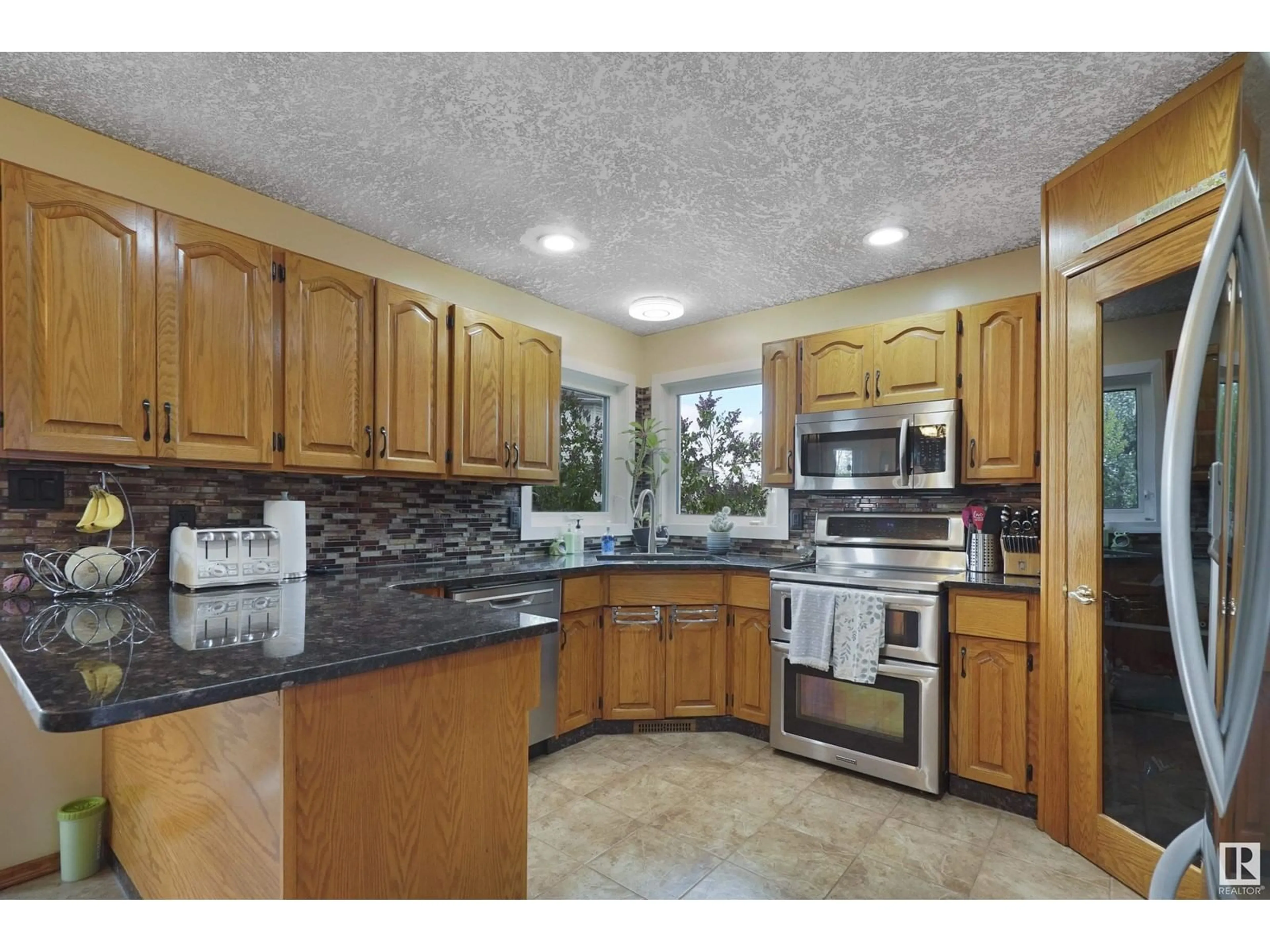 Open concept kitchen, ceramic/tile floor for 5872 159B AV, Edmonton Alberta T5Y2R5