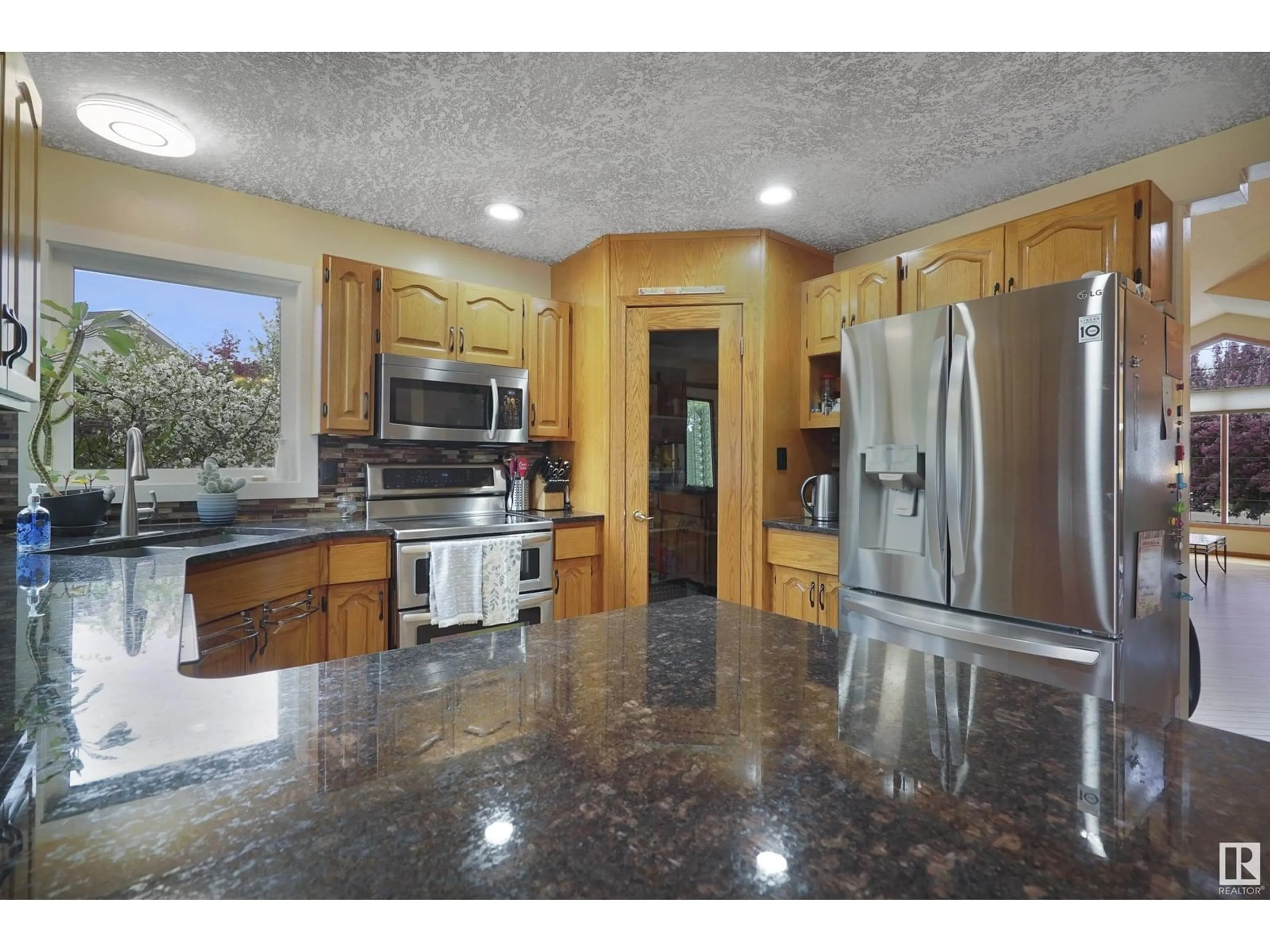 Open concept kitchen, ceramic/tile floor for 5872 159B AV, Edmonton Alberta T5Y2R5