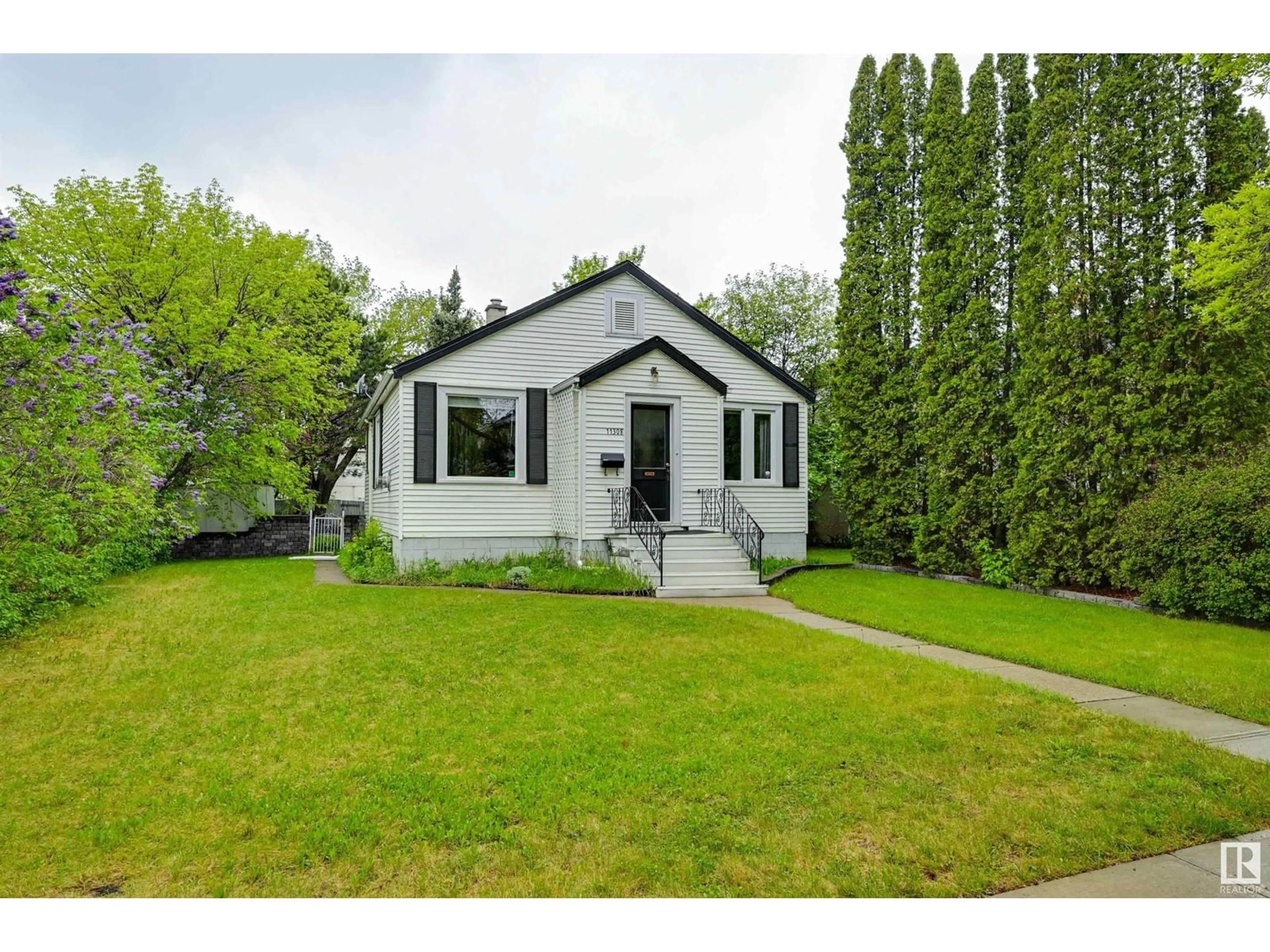 Home with vinyl exterior material, street for NW - 11308 123 ST, Edmonton Alberta T5M0E9