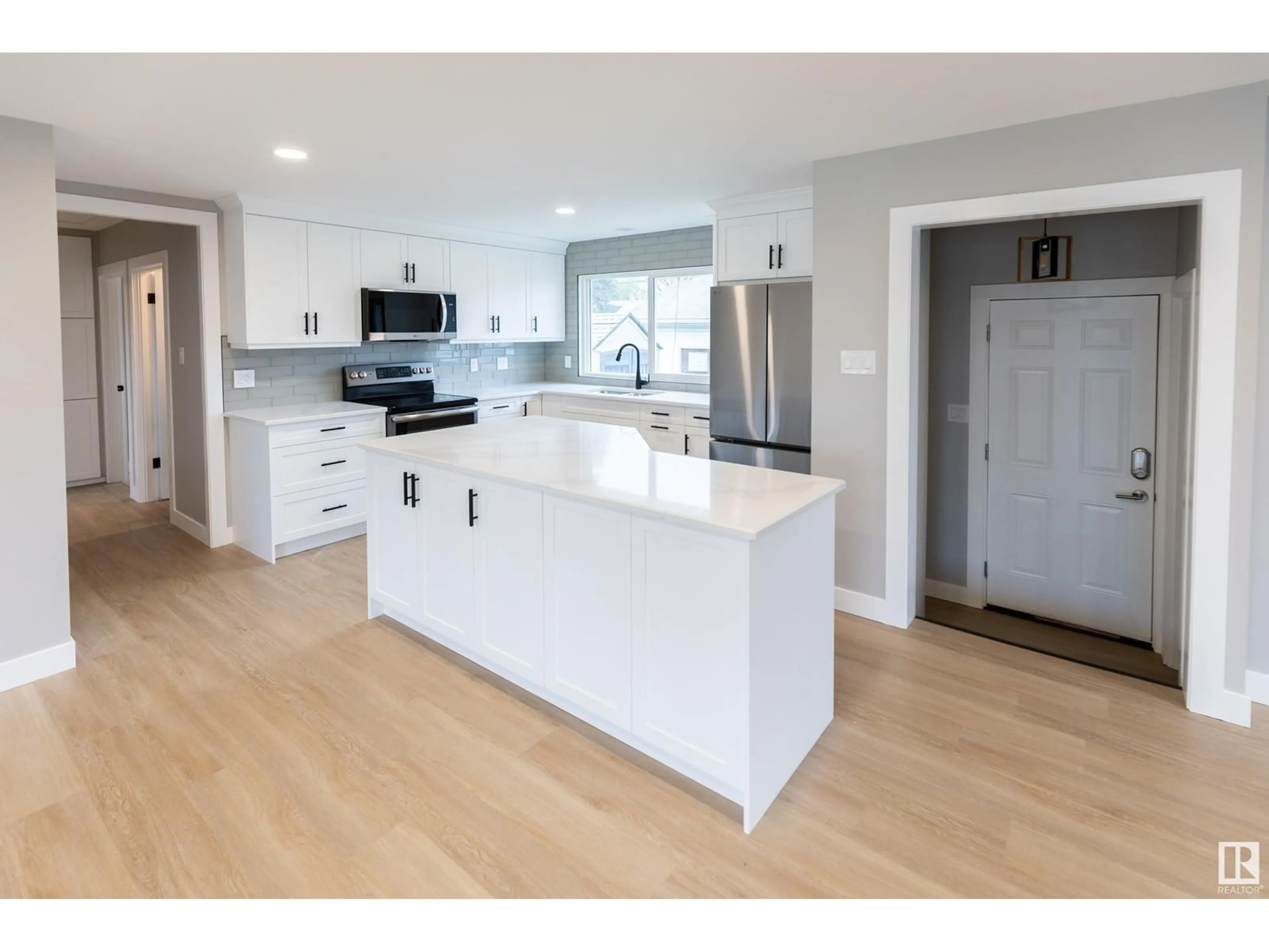 Open concept kitchen, wood/laminate floor for 9104 130 AV, Edmonton Alberta T5E0S2