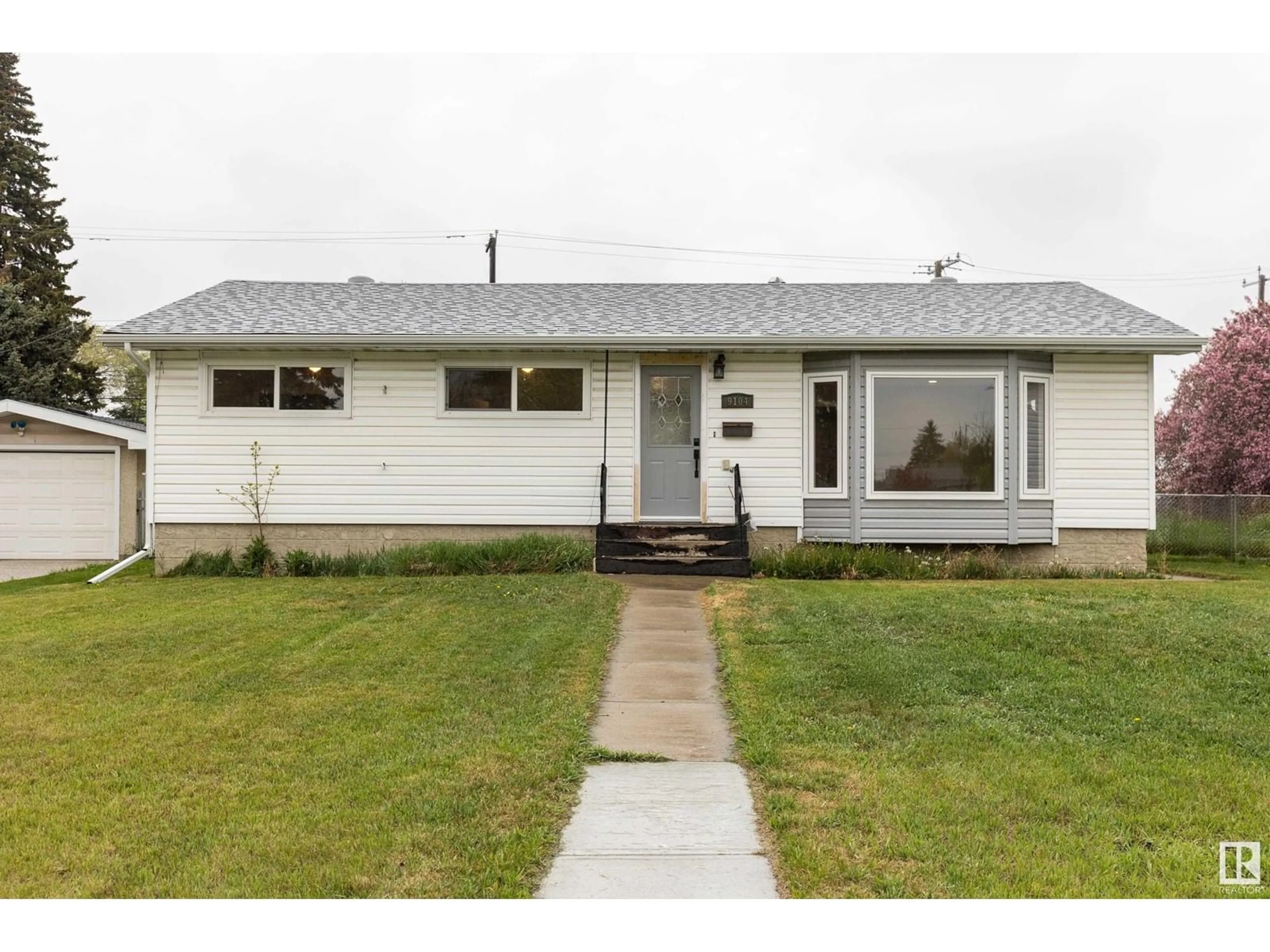 Home with vinyl exterior material, street for 9104 130 AV, Edmonton Alberta T5E0S2