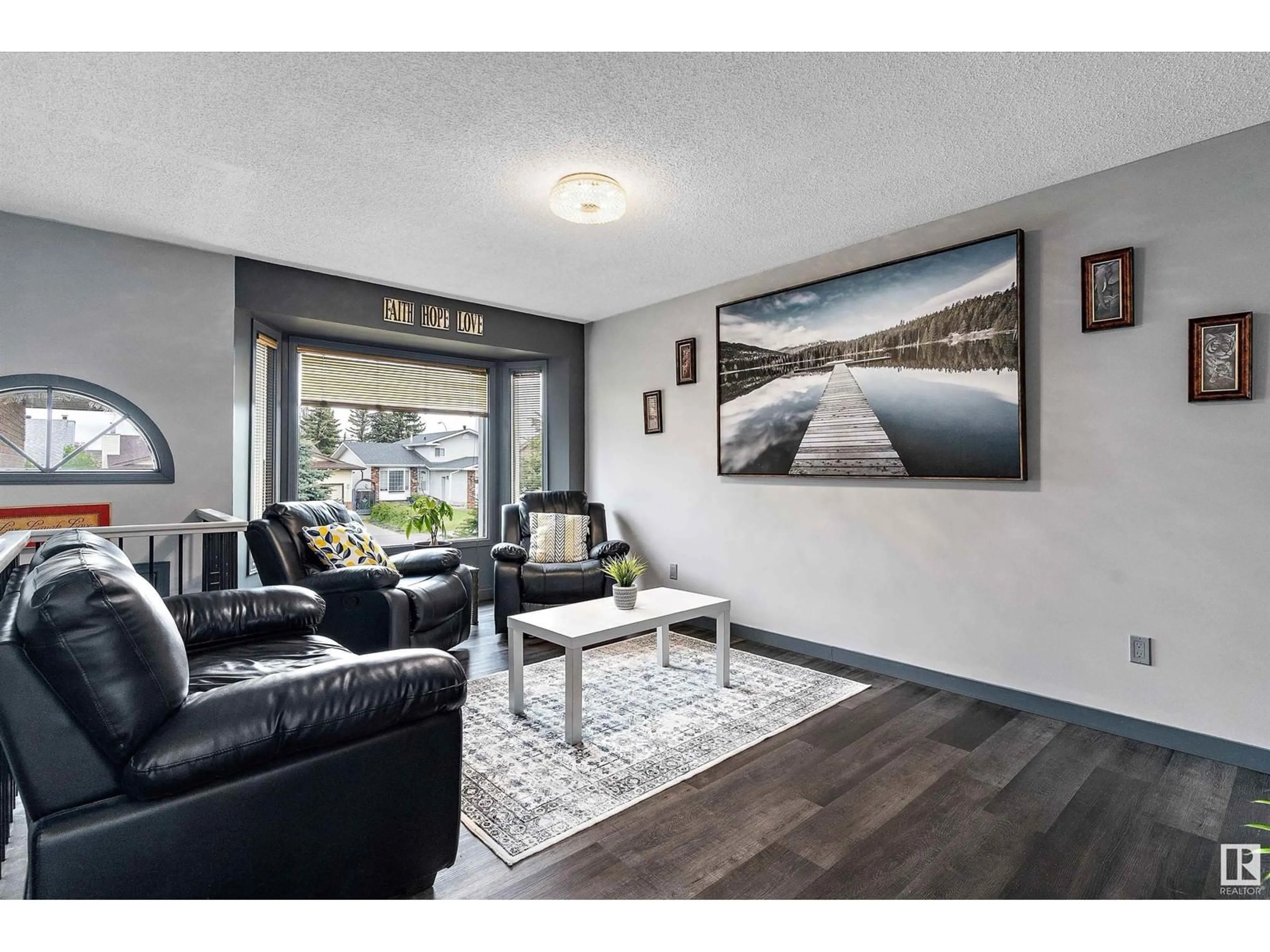 Living room with furniture, wood/laminate floor for 7259 152C AV, Edmonton Alberta T5C3L9