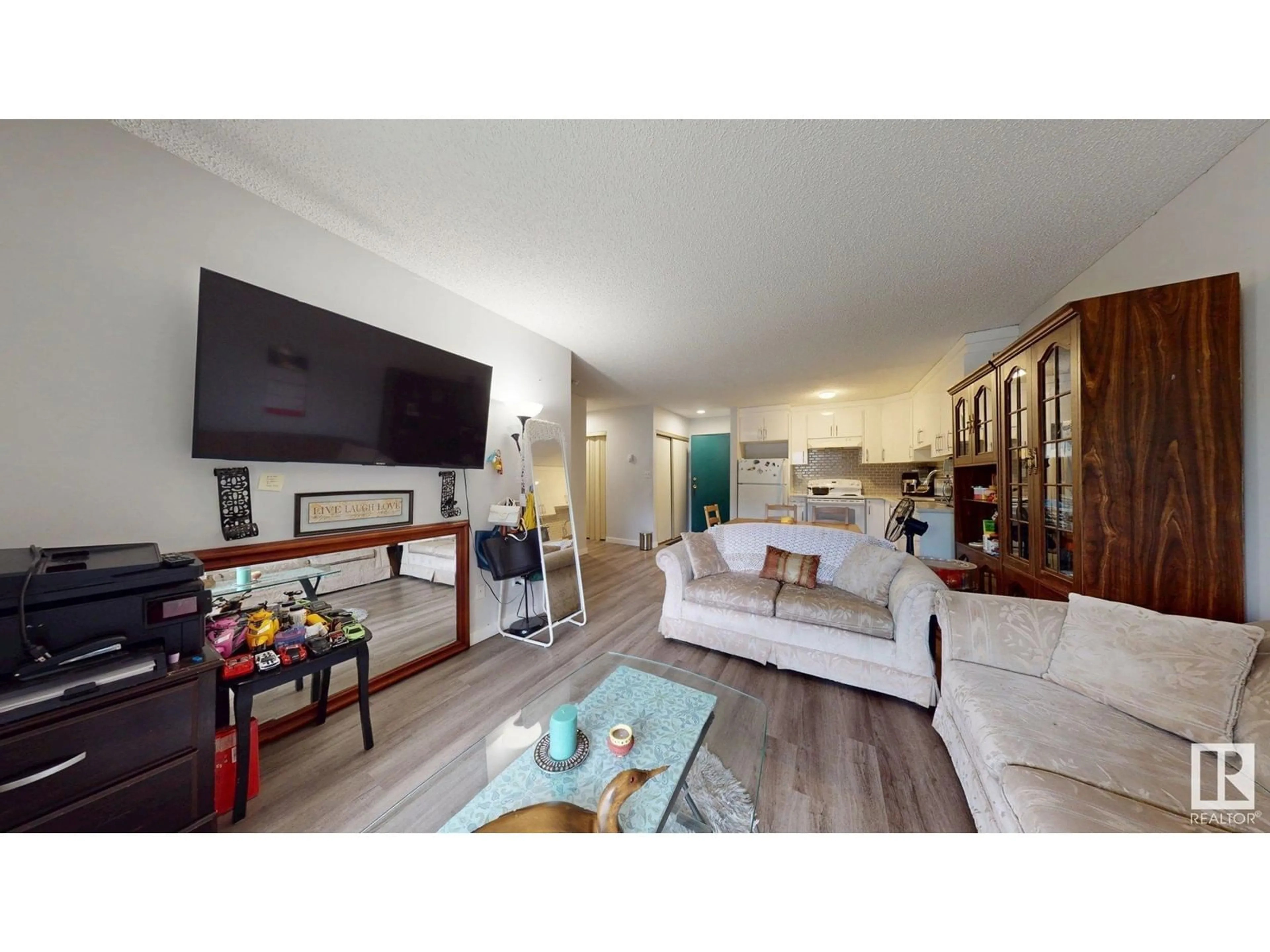 Living room with furniture, wood/laminate floor for 209 - 2620 MILL WOODS E NW, Edmonton Alberta T6L5K6